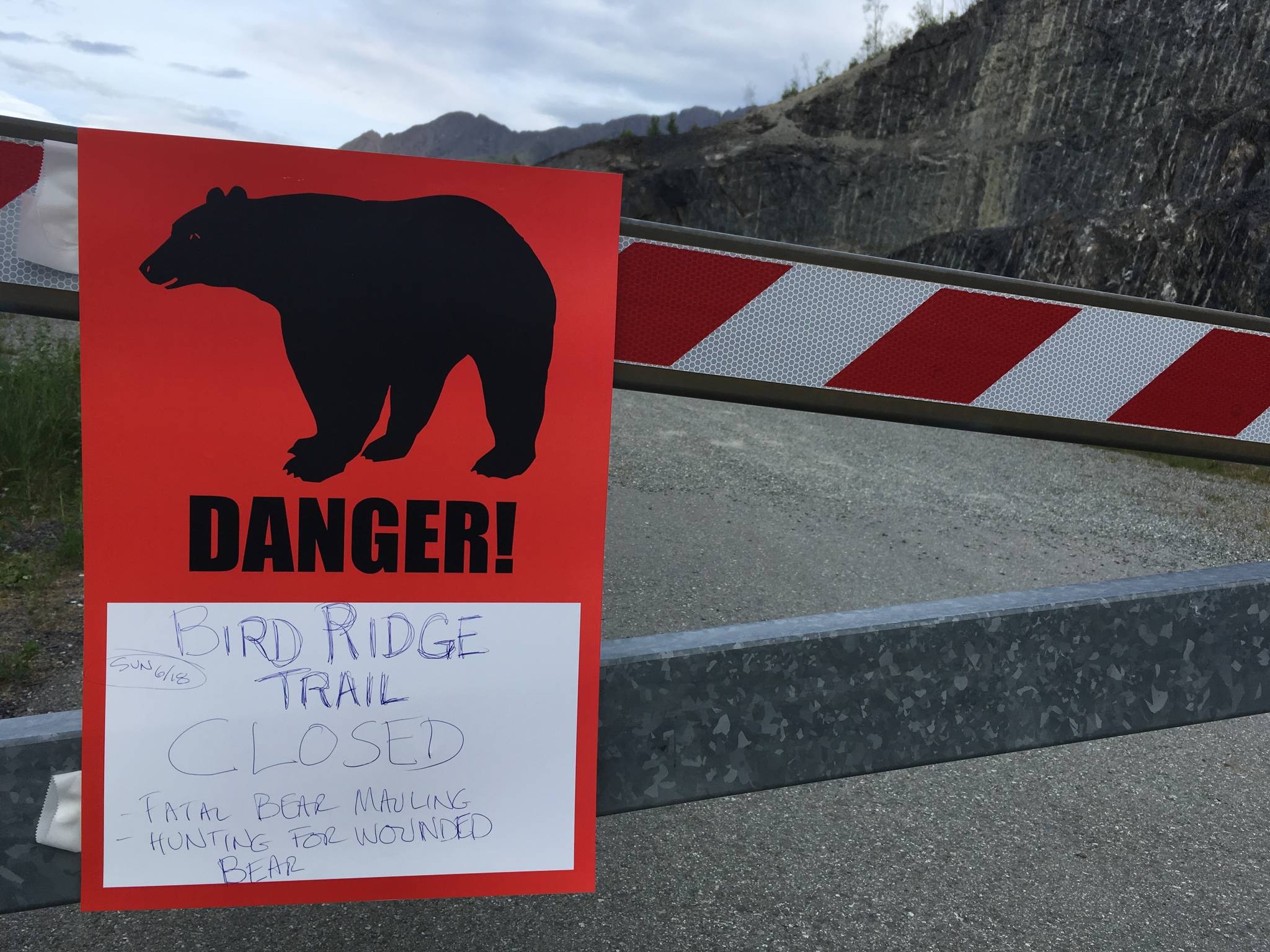 A sign warns people that the trail head is closed on Monday, June 19, 2017, after a fatal bear mauling at Bird Ridge Trail in Anchorage, Alaska. Authorities say a black bear killed a 16-year-old runner while he was competing in an Alaska race on Sunday. (Mark Thiessen | The Associated Press)