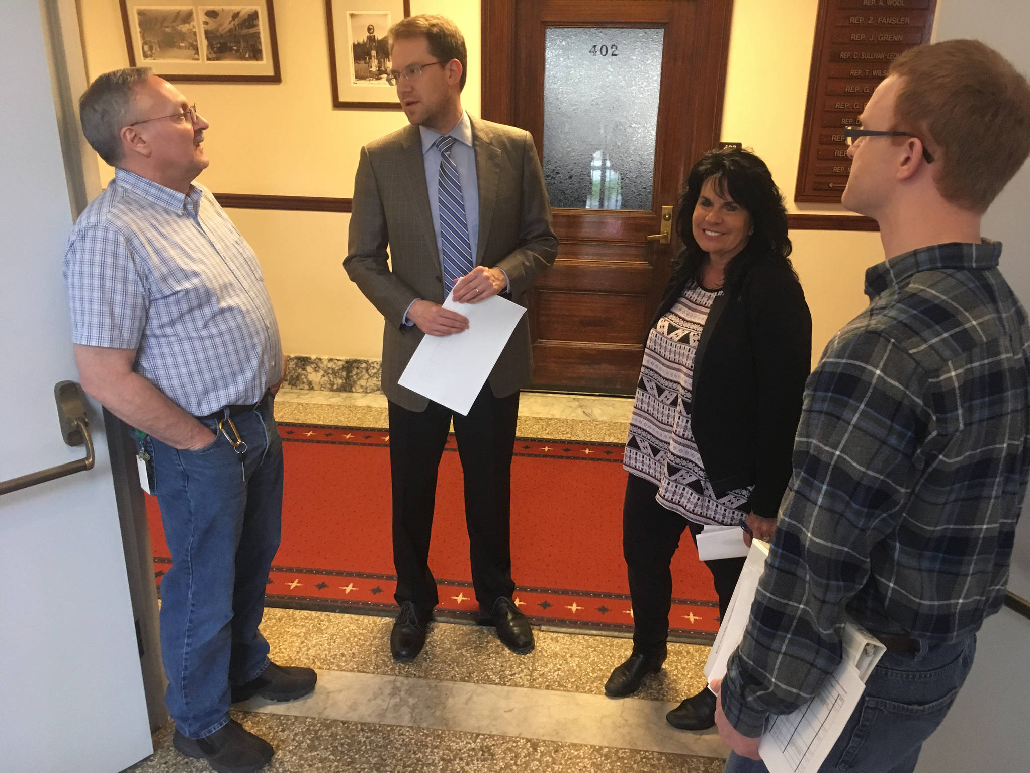 Members of the Republican House Minority discuss Legislative matters in the stairwell of the Alaska Capitol on Wednesday, June 21, 2017. From left to right are Rep. David Talerico, R-Healy; Rep. Lance Pruitt, R-Anchorage; Rep. Cathy Tilton, R-Eagle River; and Rep. David Eastsman, R-Wasilla. (James Brooks | Juneau Empire)