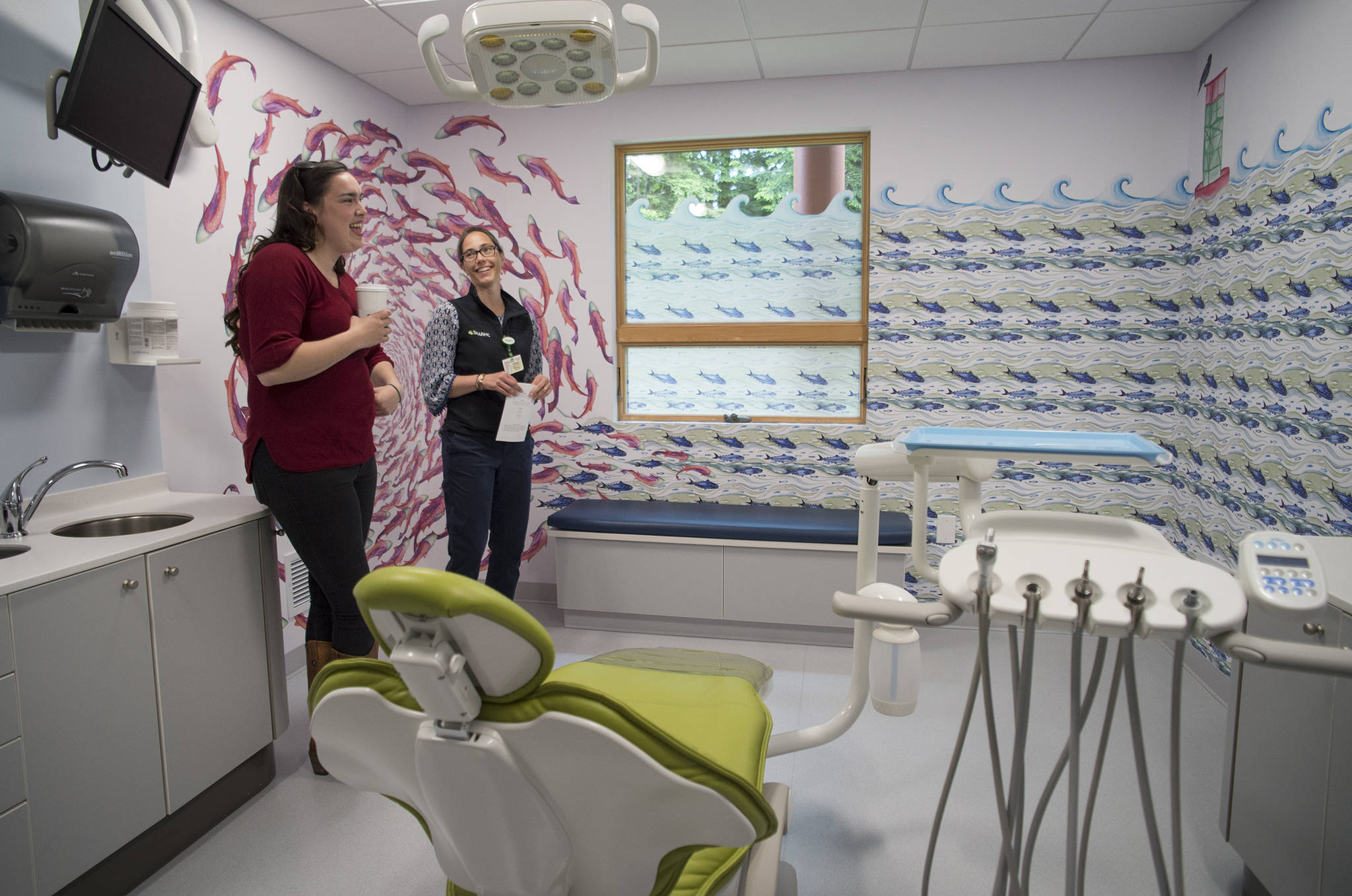 Case Manager Sydney Akagi, left, and Dr. Kim Hort, Pediatric Dentist Manager, admire one of the rooms in the SouthEast Alaska Regional Health Consortium’s new Children’s Dental Clinic during a Grand Opening on Thursday, June 22, 2017. Agaki’s watercolor paintings were use to decorate all the rooms in the clinic. (Michael Penn | Juneau Empire)