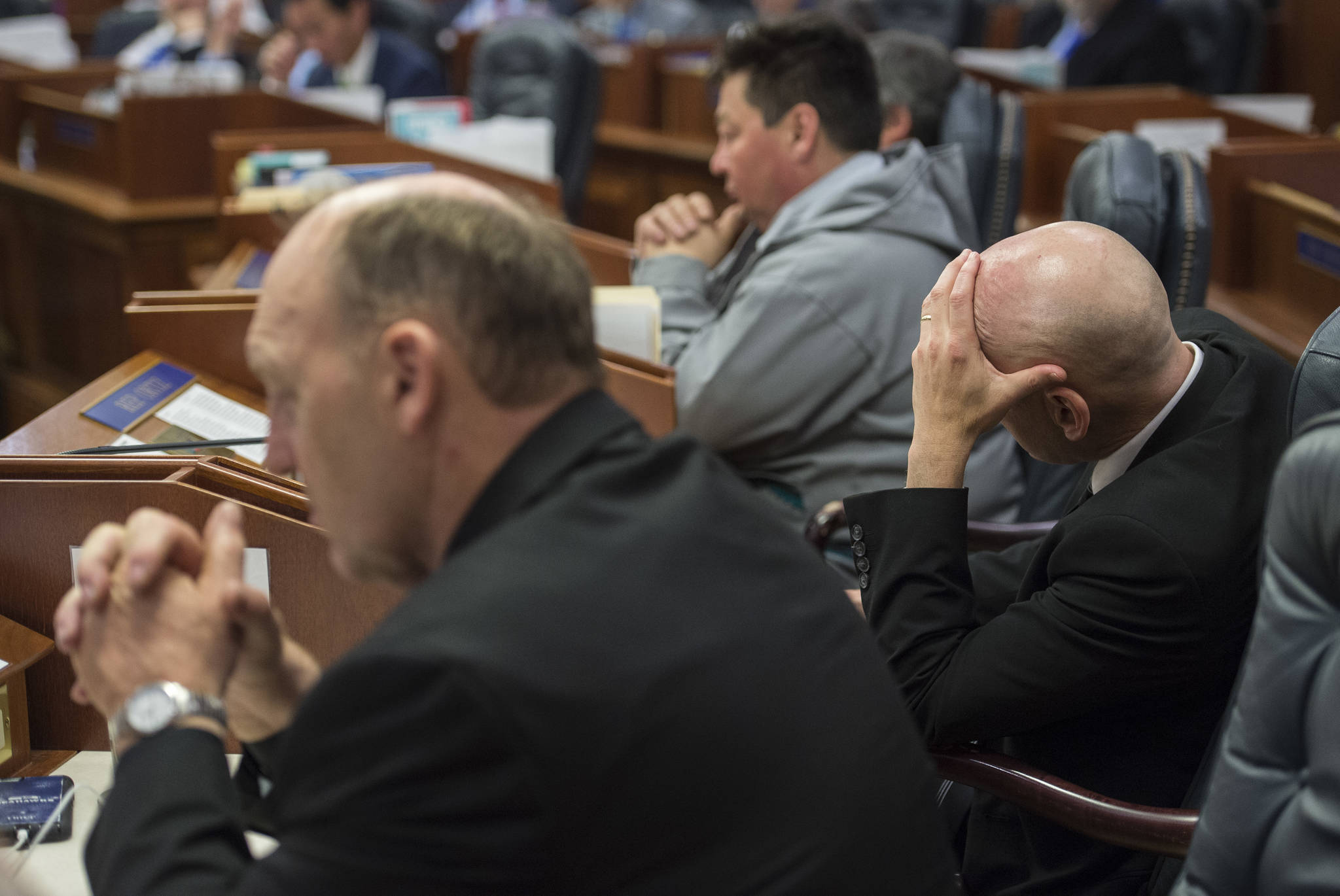 Rep. Gary Knopp, R-Kenai, left, Rep. Daniel Ortiz, I-Ketchikan, right, and Rep. Dean Westlake, D-Kotzebue, listen to debate on the state budget Thursday, June 23, 2017. Both the House and Senate voted to approve a budget and keep the State of Alaska from shutting down on July 1. (Michael Penn | Juneau Empire)
