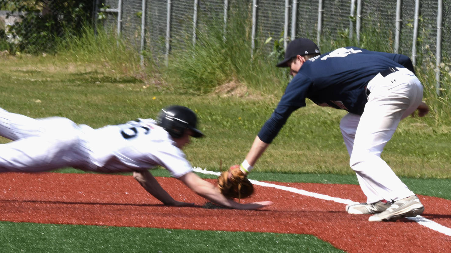 Juneau Post 25’s Bryce Swofford tags out a Chugiak base runner on Sunday, June 25, at Oberg Field in Chugiak. (Photo courtesy of Jeremy Ludeman)