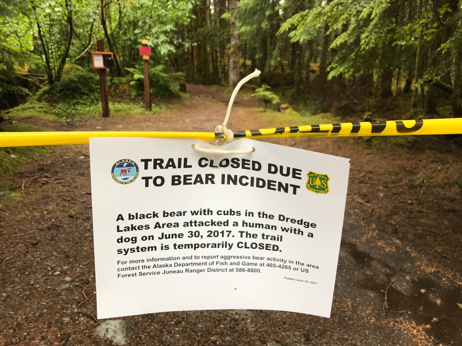 A warning sign posted off Glacier Spur Road where two state trooper vehicles were also parked. (Michael Penn | Juneau Empire)