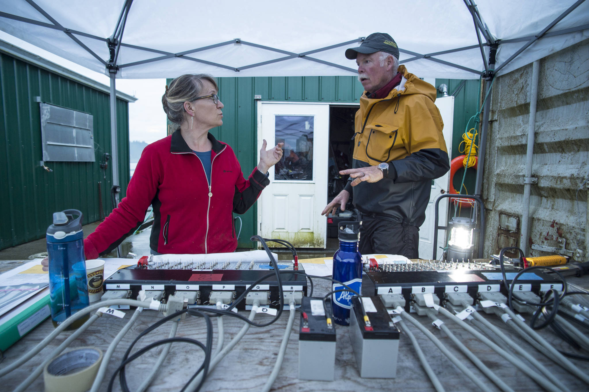 Volunteers Sigrid Dahlberg, left, and Gary Stambaugh work to set up the annual city-funded fireworks show in Juneau’s downtown harbor on Tuesday, July 3, 2017. (Michael Penn | Juneau Empire)