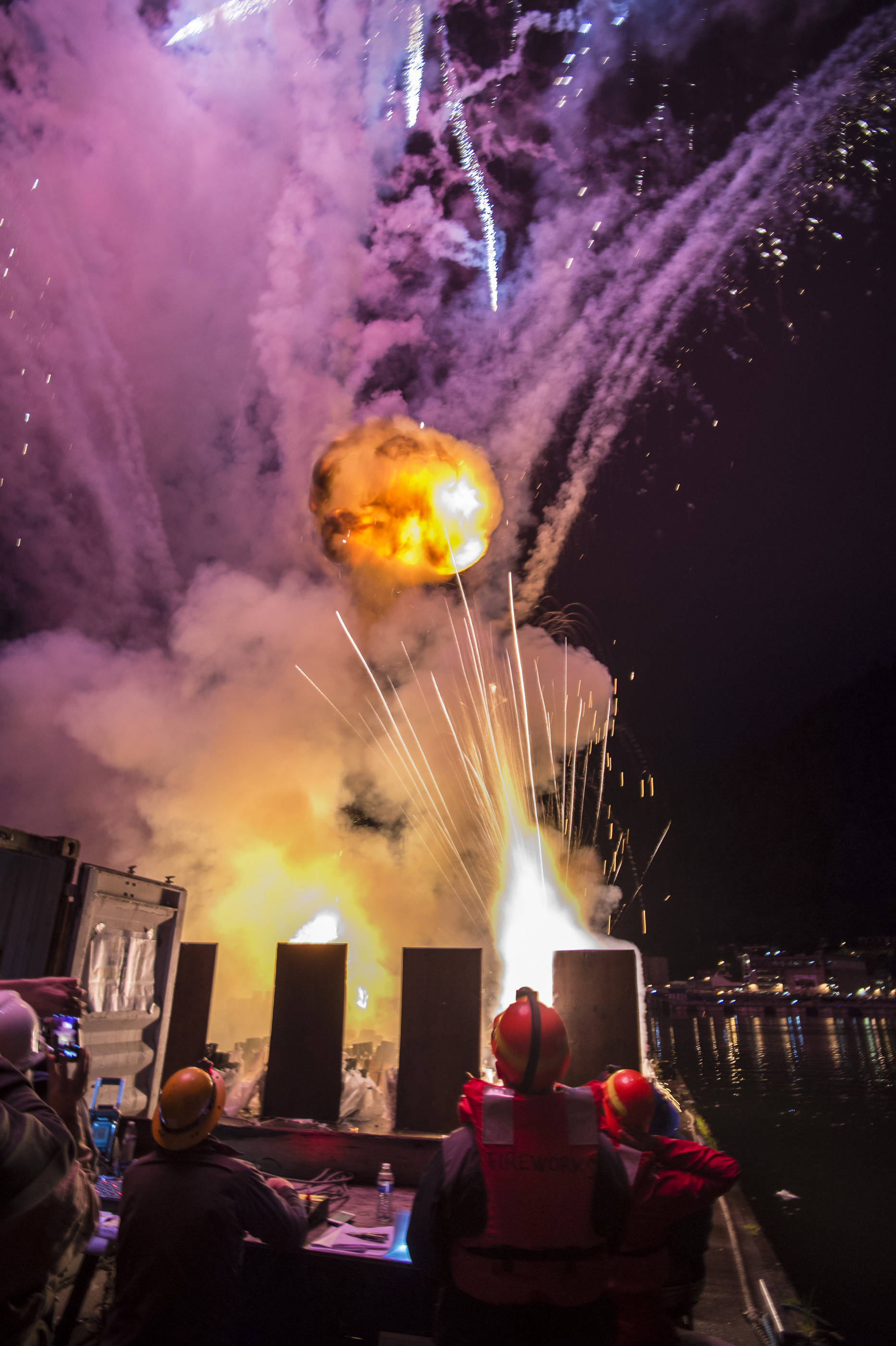 Volunteers set off a cremora fireball along with other exposives during the annual city-funded fireworks show in Juneau’s downtown harbor on Tuesday, July 3, 2017. (Michael Penn | Juneau Empire)
