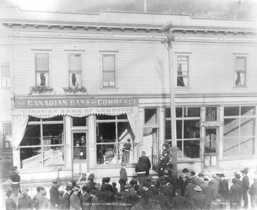 Bank after attempted robbery looking northeast on Sept. 15, 1902. Photo by William H. Case and Horace H. Draper. Image courtesy of the Alaska State Library. Identifier: ASL-P39-0466.