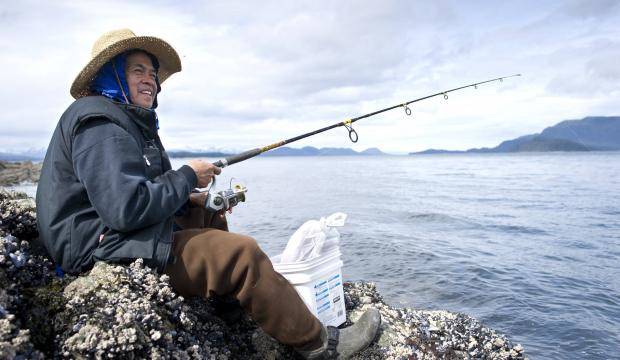 Peter Edillor fishes off the rocks at False Outer Point for king salmon in April 2016. (Michael Penn | Juneau Empire file)