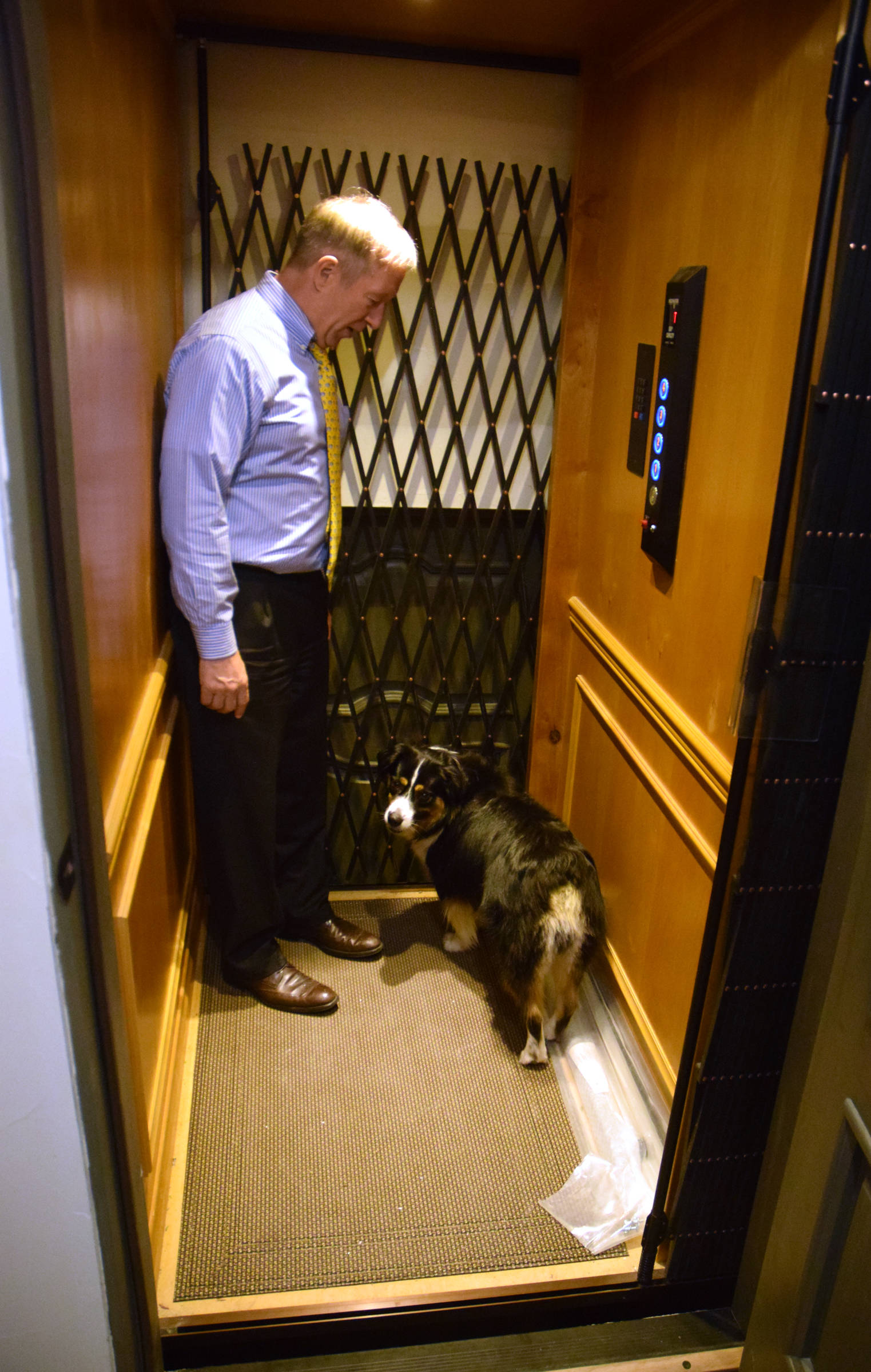 Mark Choate rides the elevator of his new house with his dog, Obi Wan Kenobi, on Thursday, July 6, 2017. (James Brooks | Juneau Empire)