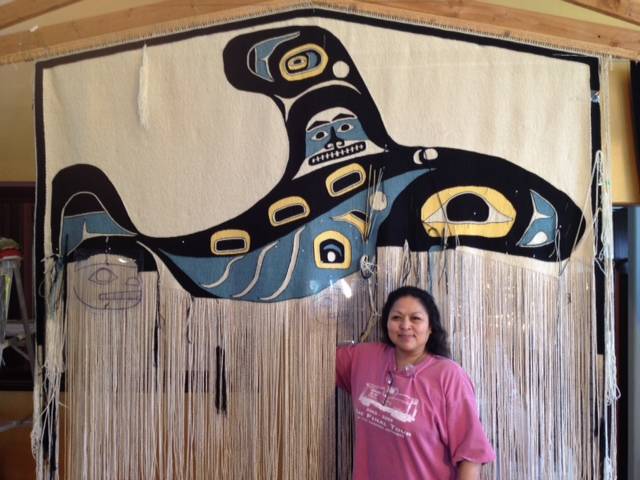 Anna Brown Ehlers and the Killer Whale Chilkat blanket, the longest Chilkat blanket in history. It’s eight feet wide and seven feet long. Courtesy image.