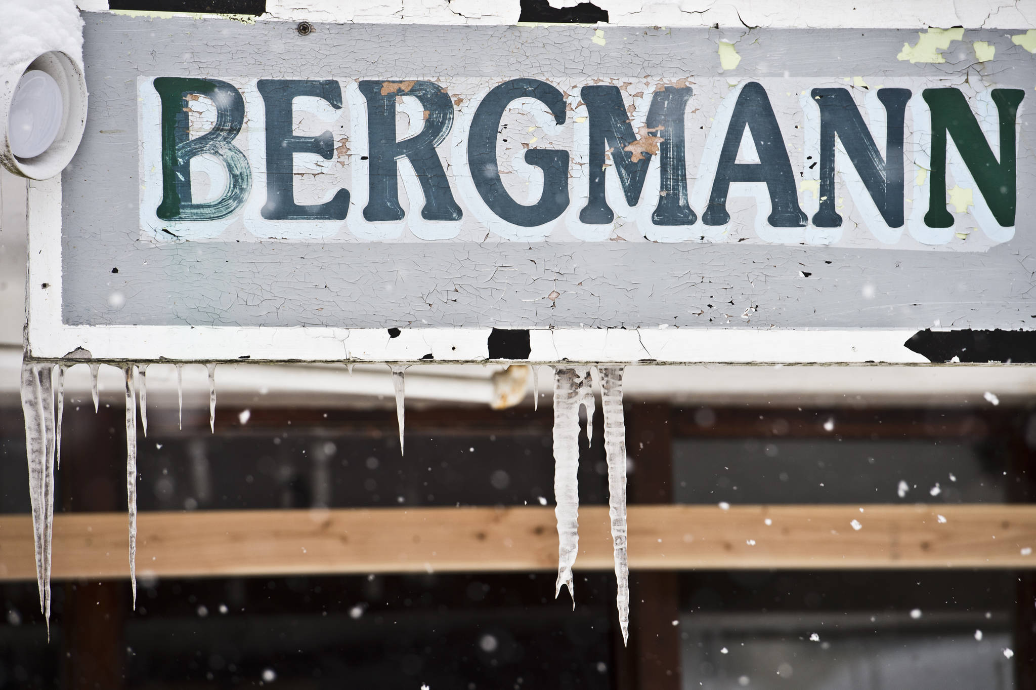 Chipped paint and icycles hang from the Bergmann Hotel sign on Monday, March 13, 2017. (Michael Penn | Juneau Empire)