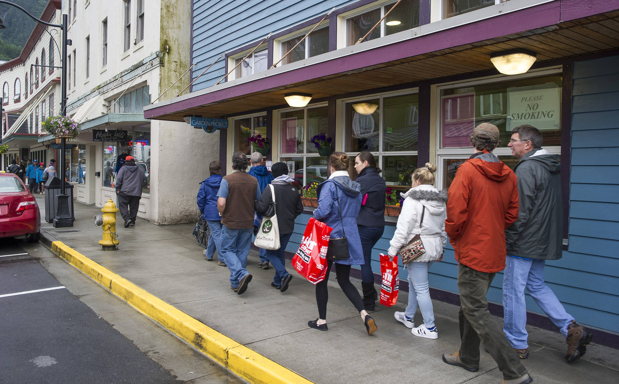 Tourists walk by The Glory Hole, Juneau’s soup kitchen and homeless shelter, on Tuesday, July 11, 2017. The city is considering moving The Glory Hole out of downtown. (Michael Penn | Juneau Empire)