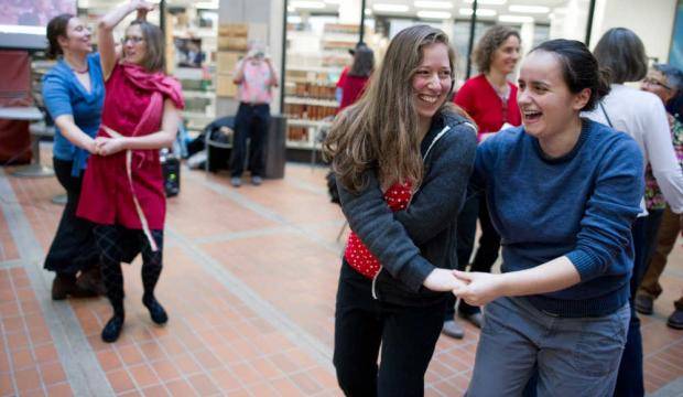 In this 2013 file photo, Claudia Plesa, right, dances with Emily Wolf during an event in the State Office Building. (Michael Penn | Juneau Empire)