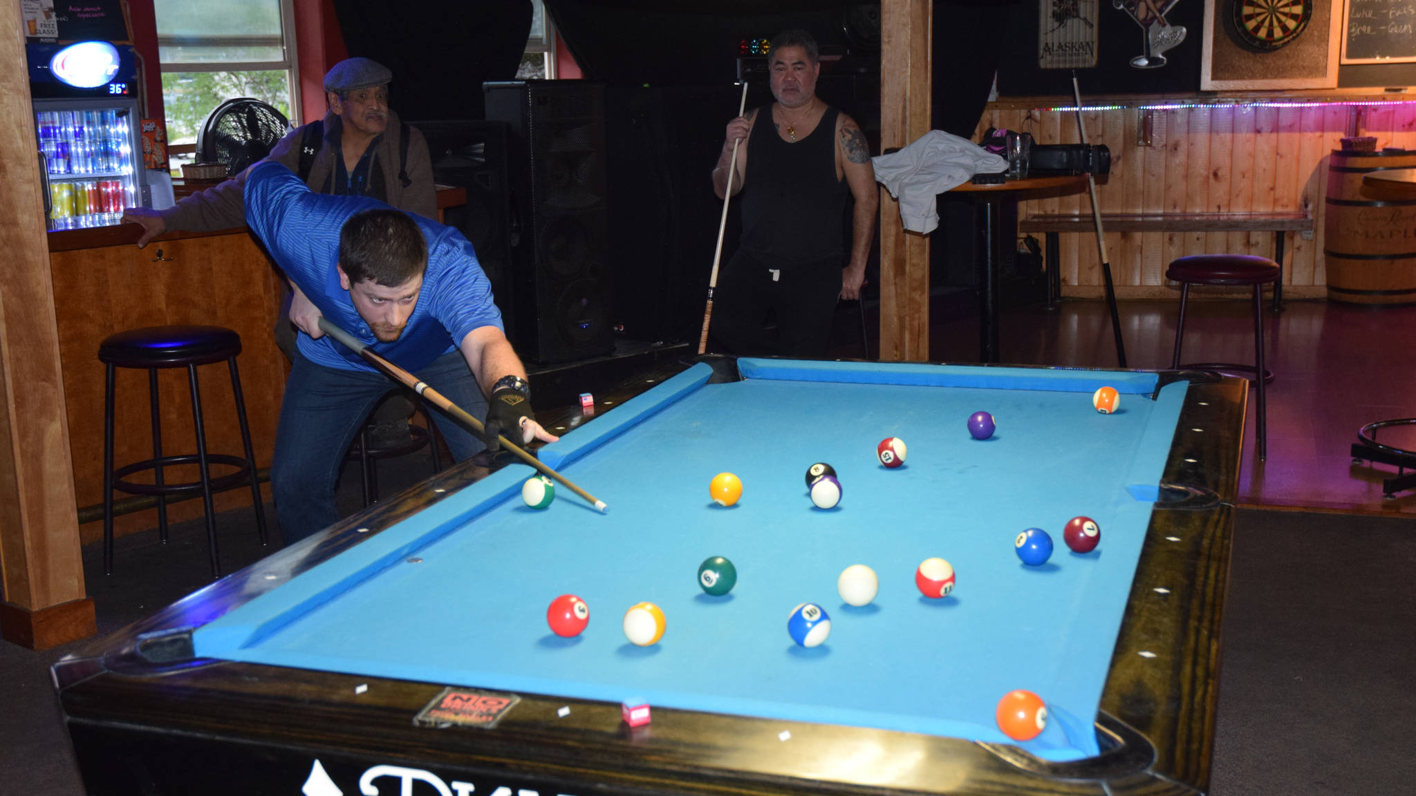 Mark Rackley lines up a shot while playing a game of pool against Jerry Carillo at a Thursday practice for the Juneau Billiards Association. (Kevin Gullufsen | Juneau Empire)