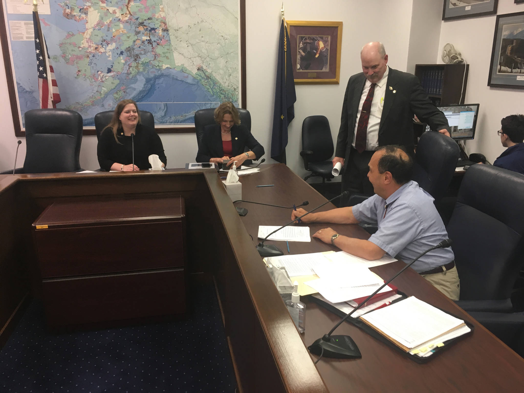 At right, Sen. Donny Olson, D-Nome, prepares to sign the conference committee report for House Bill 111 as it heads to votes of the full House and full Senate on Saturday night, July 15, 2017 in the Alaska State Capitol. (James Brooks | Juneau Empire)