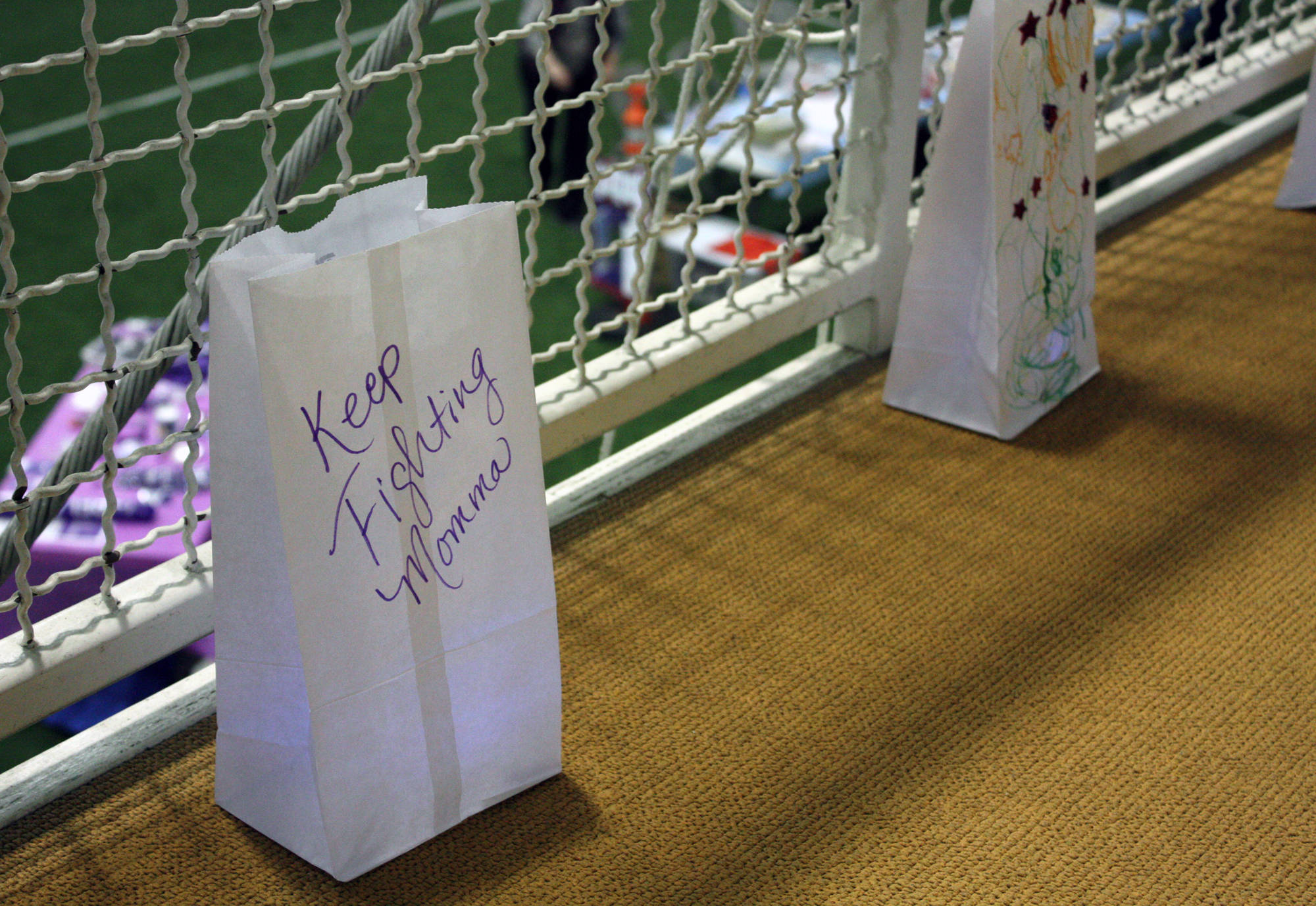 Luminara bags line the track at the Dimond Park Field House during the 2017 Relay For Life event Friday, July 14, 2017. (Erin Laughlin | For the Juneau Empire)