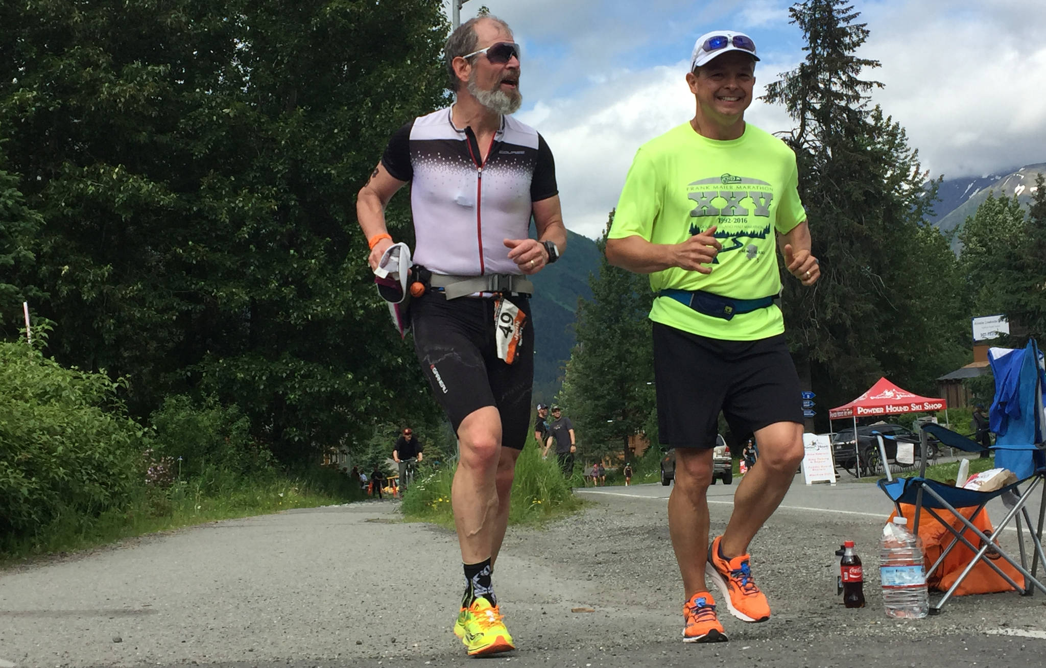 Juneau resident John Bursell (left) reaches mile 20 of the Alaskaman Extreme Triathlon on Saturday, July 15, alongside support crew member Darren Booton (right). Bursell was the top finisher from Juneau, coming in 19th place out of 151 finishers. (Photo courtesy of Jamie Bursell)