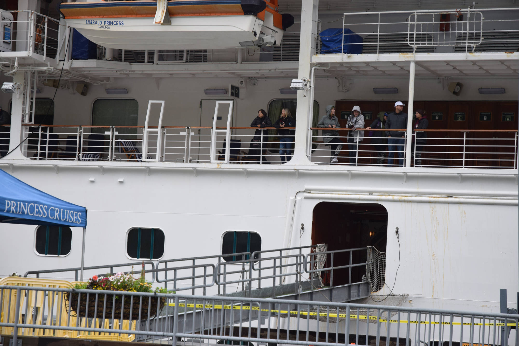 Police tape surrounds an entrance to the Emerald Princess as passengers wait for an announcement allowing them to disembark Wednesday in Juneau. (Liz Kellar | Juneau Empire)