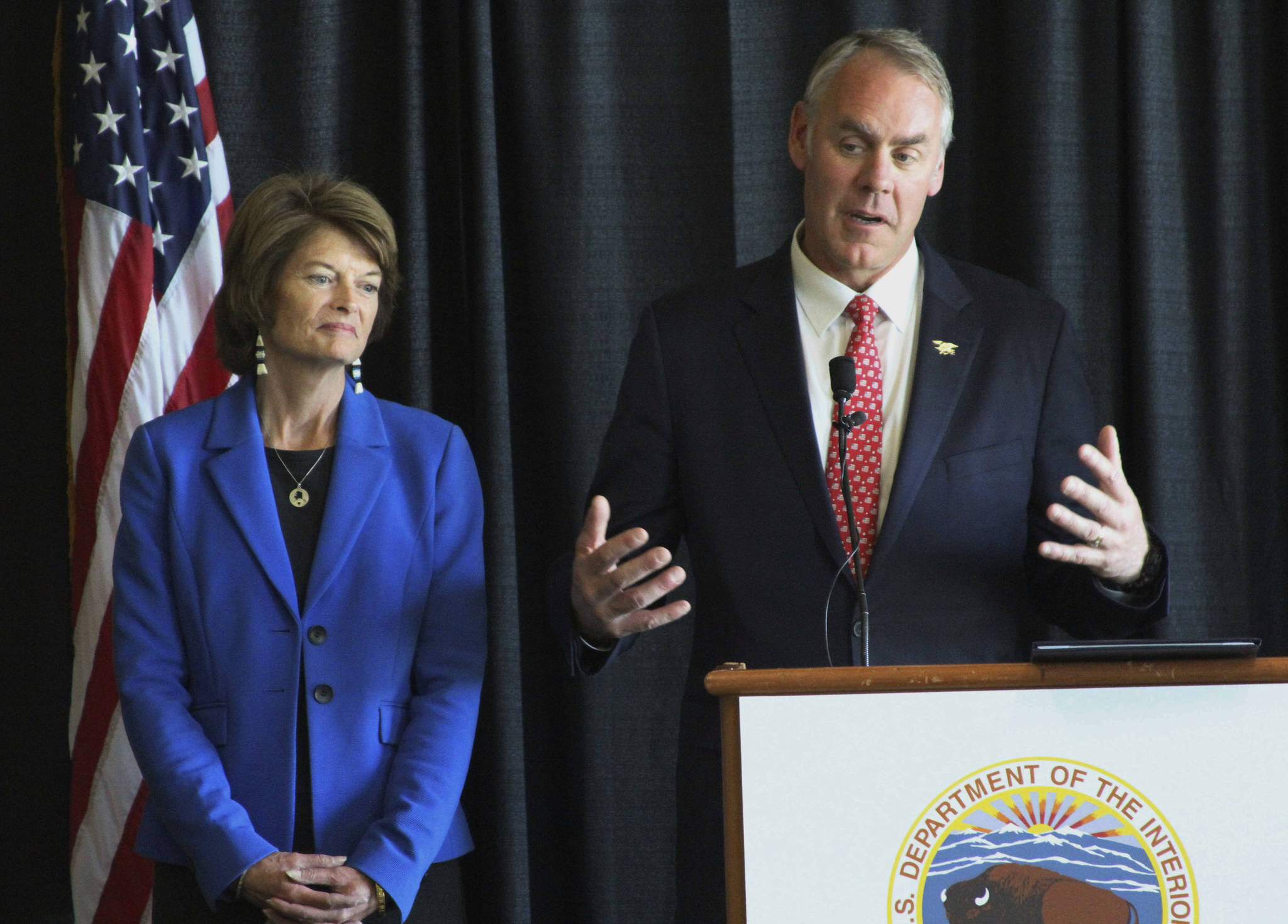 In this May 31 photo, Interior Secretary Ryan Zinke, right, with U.S. Sen. Lisa Murkowski, R-Alaska, speaks during a news conference in Anchorage. Zinke called Alaska’s two Republican senators, Murkowski and Dan Sullivan, to warn them of repercussions for the nation’s largest state if they failed to toe the Trump administration line on health care, according to a published report. (Mark Thiessen | The Associated Press)