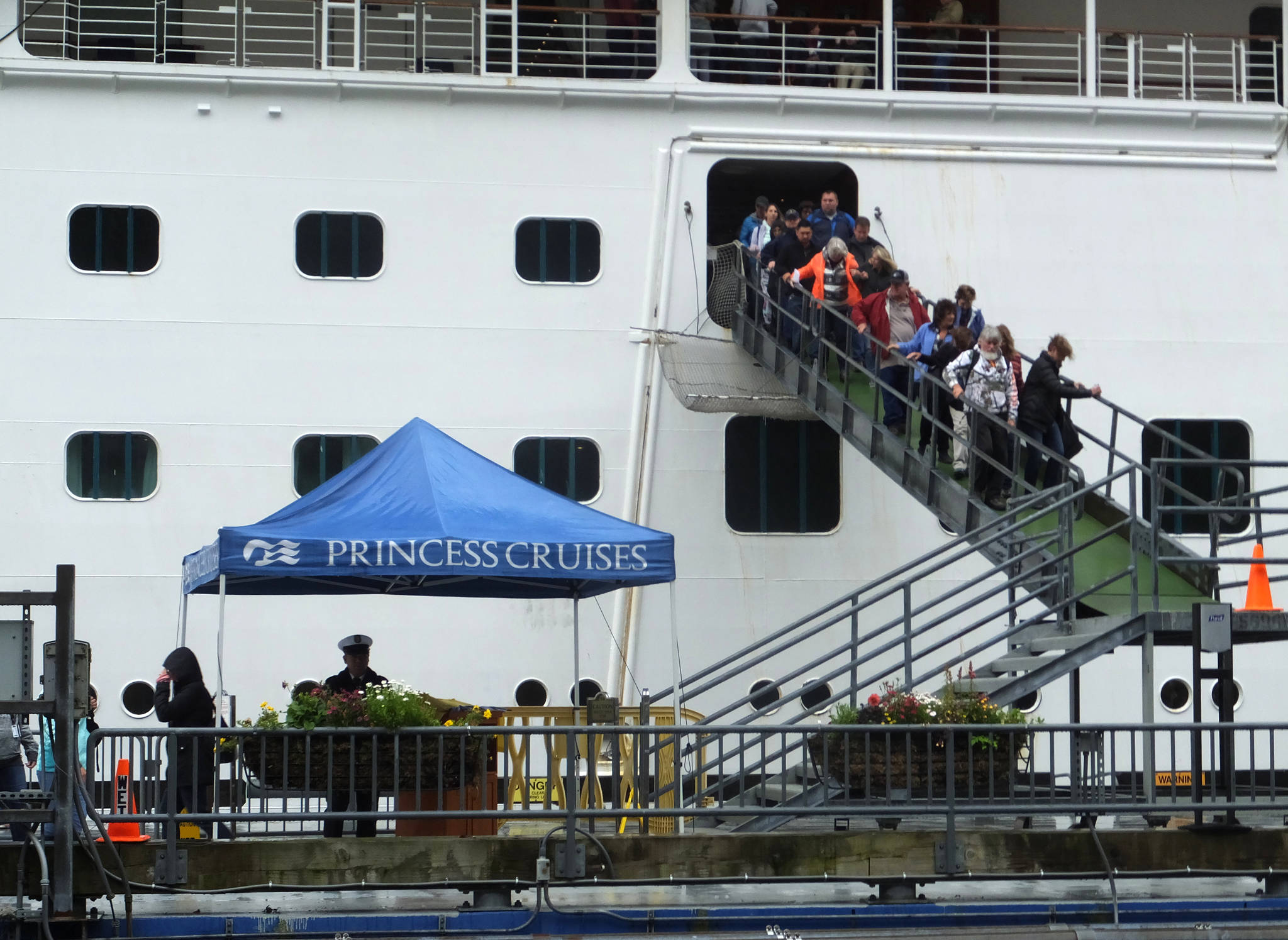 Passengers of the Emerald Princess cruise ship disembark on Wednesday, July 26, 2017, in Juneau, Alaska, hours after arriving at port. A domestic dispute aboard the cruise ship led to the death of a 39-year-old Utah woman, and the FBI is investigating what happened in U.S. waters off Alaska, the agency said Wednesday. (Becky Bohrer | The Associated Press)