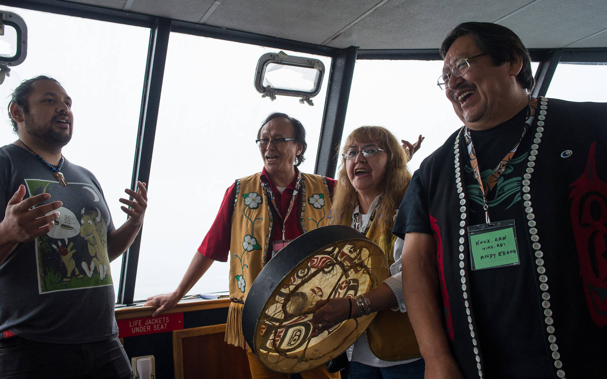 Raymond Gregory, left, Fausto Paulo, Jeannie Lee and Andy Ebona sing during the Douglas Indian Association&rsquo;s boat trip to Taku Inlet to view traditional village sites on Friday, July 28, 2017.