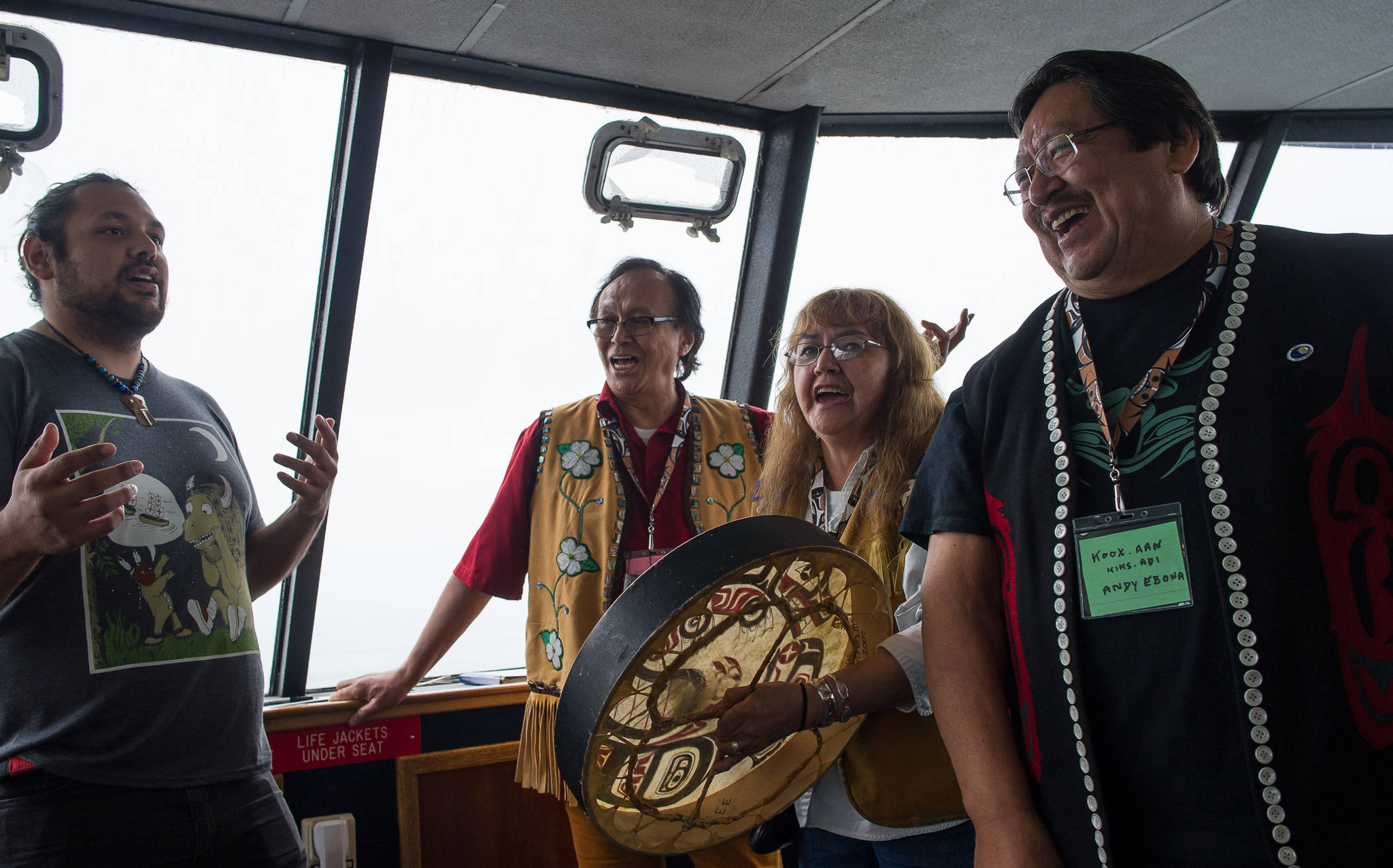 Raymond Gregory, left, Fausto Paulo, Jeannie Lee and Andy Ebona sing during the Douglas Indian Association’s boat trip to Taku Inlet to view traditional village sites on Friday, July 28, 2017.