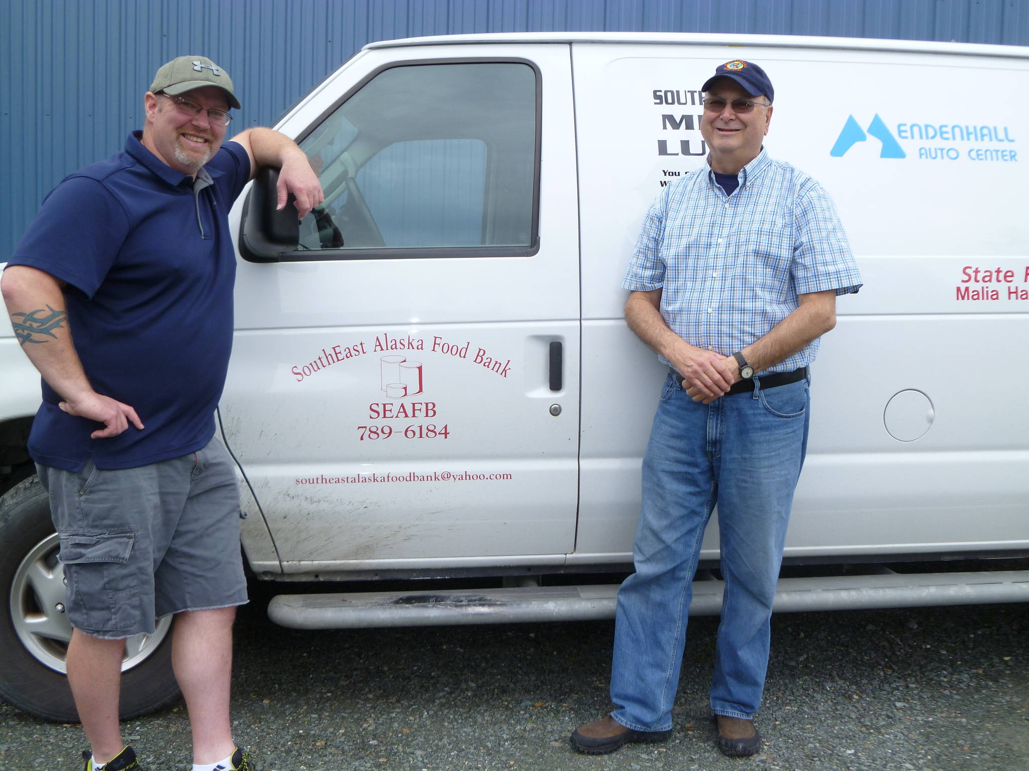 Adams and Watson stand in front of the food bank’s delivery/pick-up van. Photo by Mackenzie Fisher.