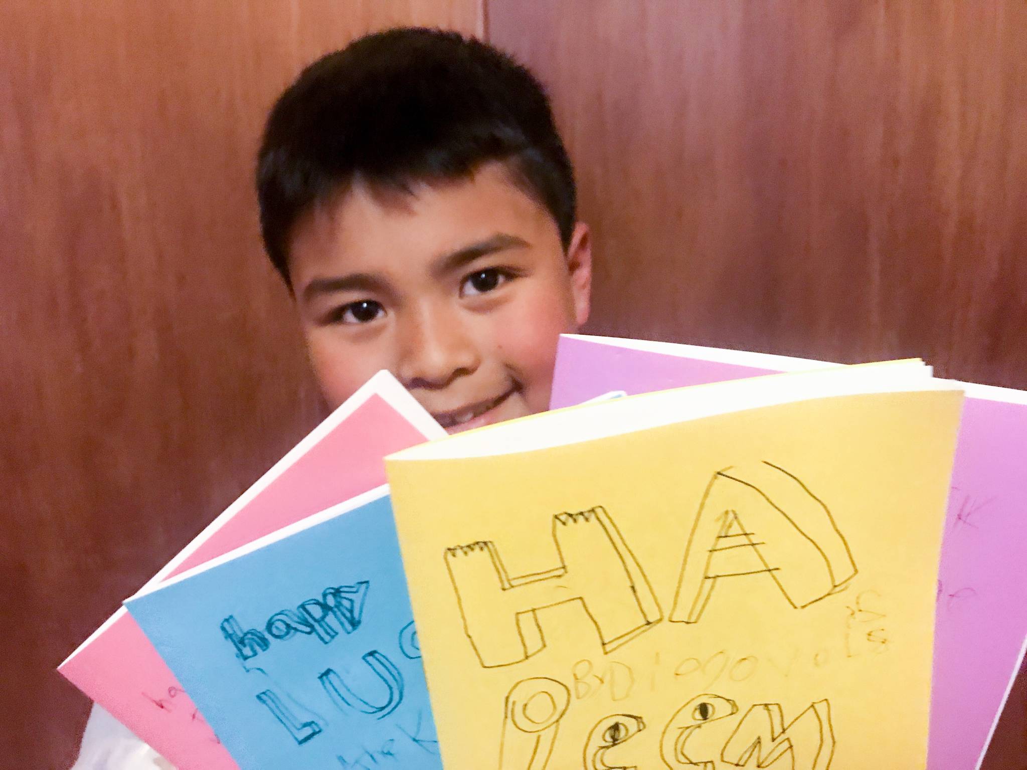 Diego SunWoo, age 8, holds volumes of his zine “Happy Mollusk.” Courtesy image.