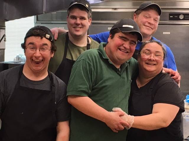Members of a supported employment program run by REACH, Inc. pose with a supervisor at the Ninth Street Cafe. REACH, an organization that serves those with disabilities, is holding a fundraiser Saturday at the Juneau Arts and Culture Center. (Photo courtesy of REACH)