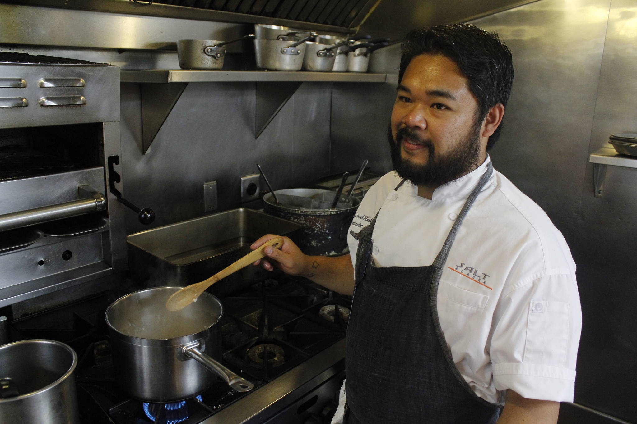SALT Executive Chef Lionel Uddipa smiles as he prepares his dish for the 2017 Great American Seafood Cookoff. Uddipa will prepare a Dungeness crab risotto to represent Alaska. (Alex McCarthy | Juneau Empire)