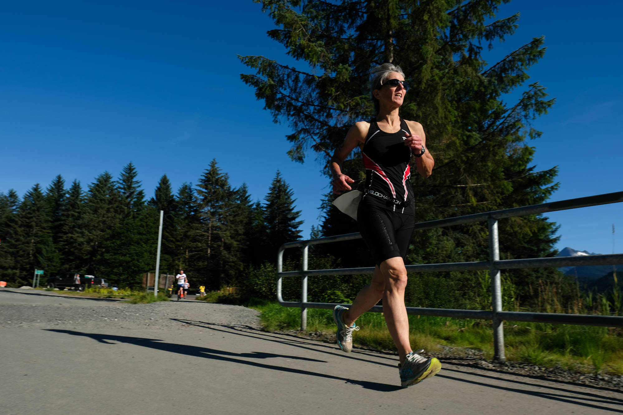 A competitor makes her way to the Auke Lake Trail Saturday during the last leg of the Aukeman Triathlon. (Konrad Frank | For the Juneau Empire)