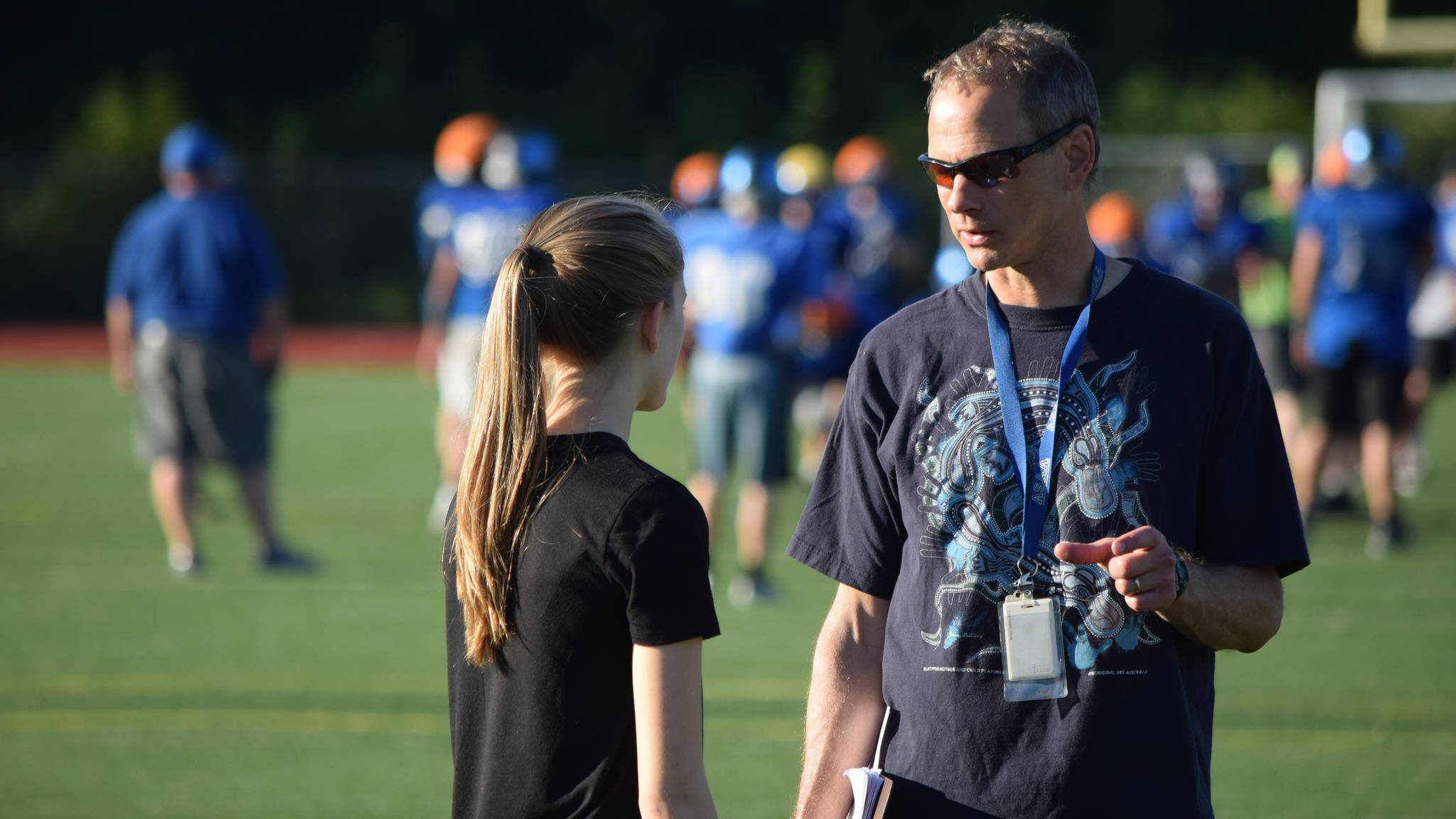 Thunder Mountain High School cross country coach Scott May, right, talks with his daughter, Mikayla, Wednesday evening near the end of practice. May announced this will be his final year coaching the TMHS cross country and track teams. The Riverbend Elementary gym teacher has been coaching track in Juneau since the early 2000&rsquo;s. (Nolin Ainsworth | Juneau Empire)