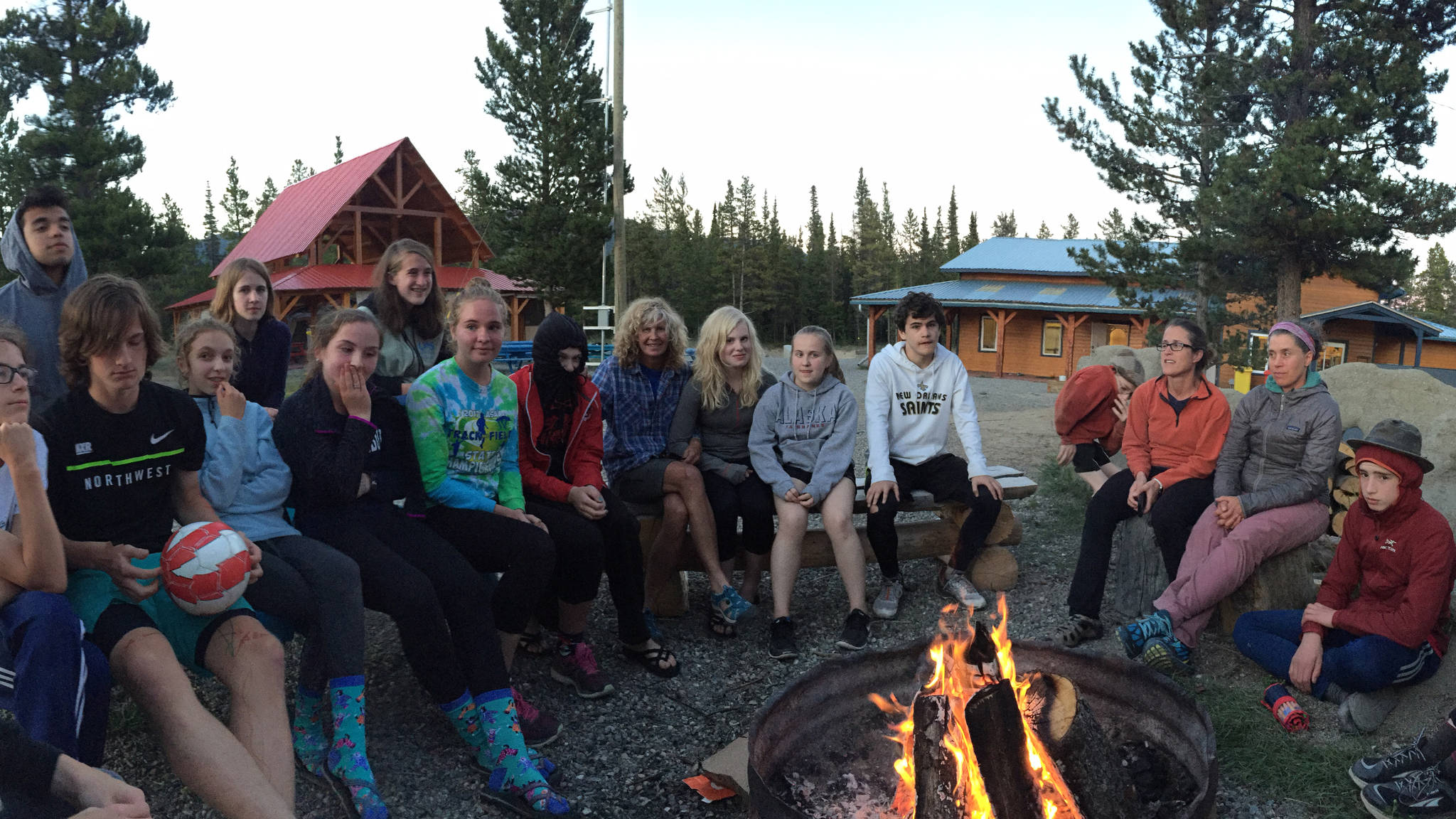 The Juneau-Douglas High School cross country team hangs out around a campfire at the Mt. Lorne Campground in the Yukon, Aug. 3. The first meet of the high school cross country season is Aug. 26 at Sandy Beach. (Photo courtesy of Tristan Knutson Lombardo)