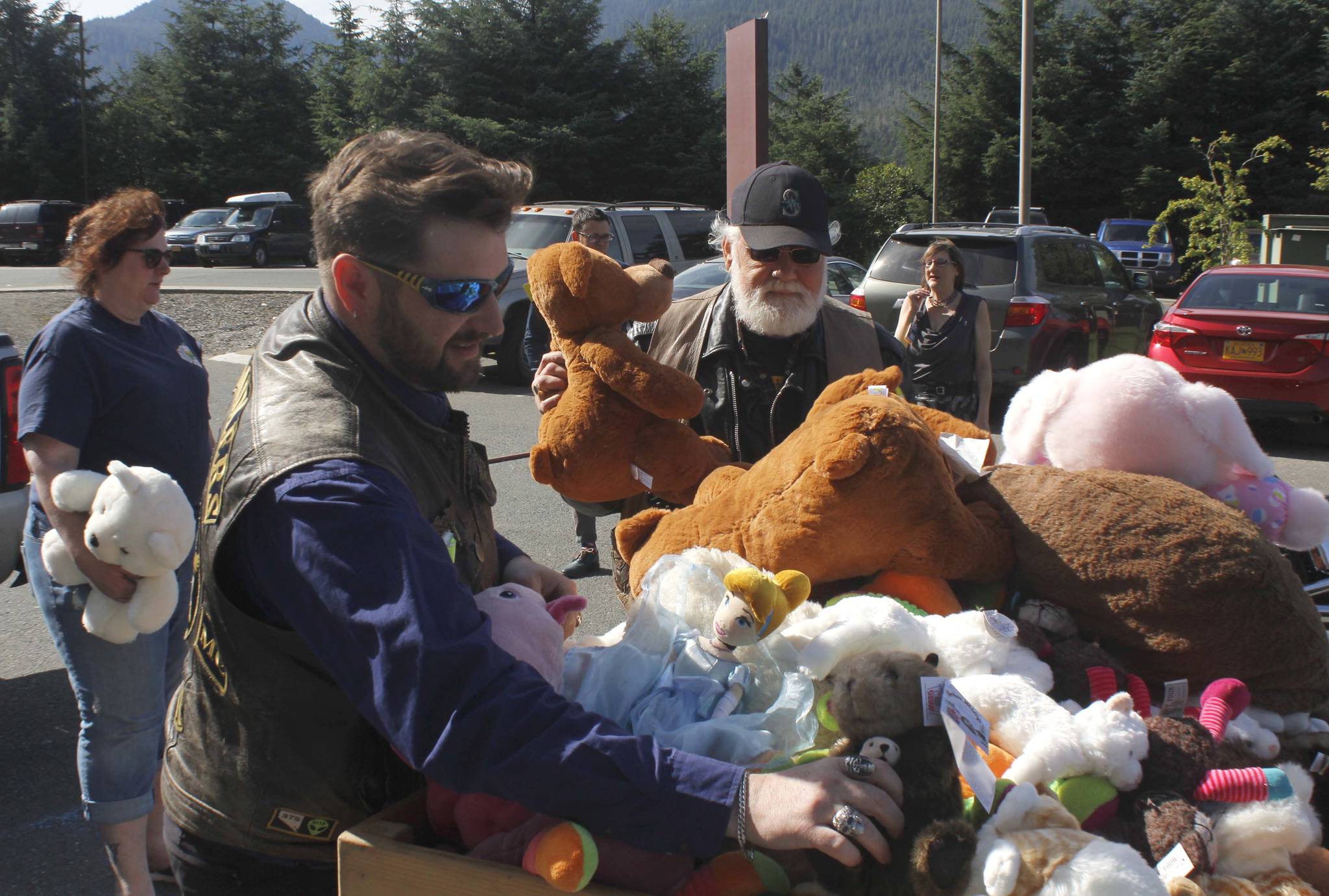 PHOTOS BY ALEX McCARTHY | JUNEAU EMPIRE Justin Papenbrock, a sergeant-at-arms for the Southeast Alaska Panhandlers Motorcycle Club, places a stuffed animal on a pile of donated toys on Thursday. The club brought 10 large trash bags of stuffed animals, raised at the 23rd annual Toy Run, to Bartlett Regional Hospital.