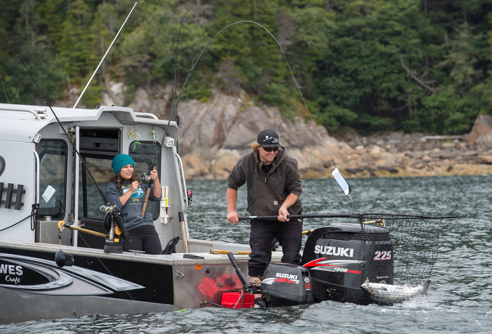 Dylan Kubley and Abbey Wilwert bring in a silver salmon during in the 71st Annual Golden North Salmon Derby on Friday, August 11, 2017. (Michael Penn | Juneau Empire)
