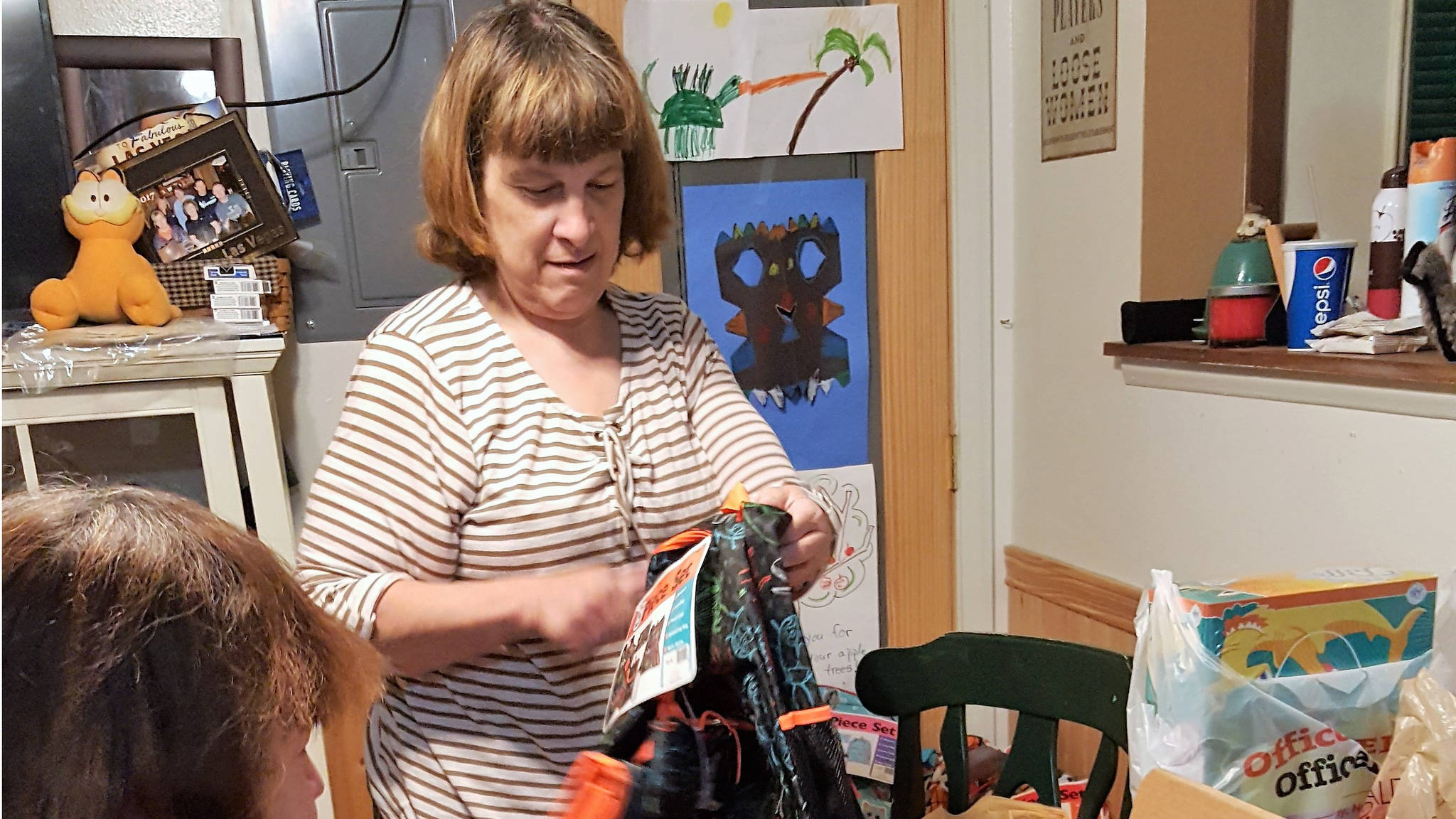 Suzanne Dutson stuffs backpacks with school supplies for children of incarcerated caregivers. (Photo courtesy Suzanne Dutson)