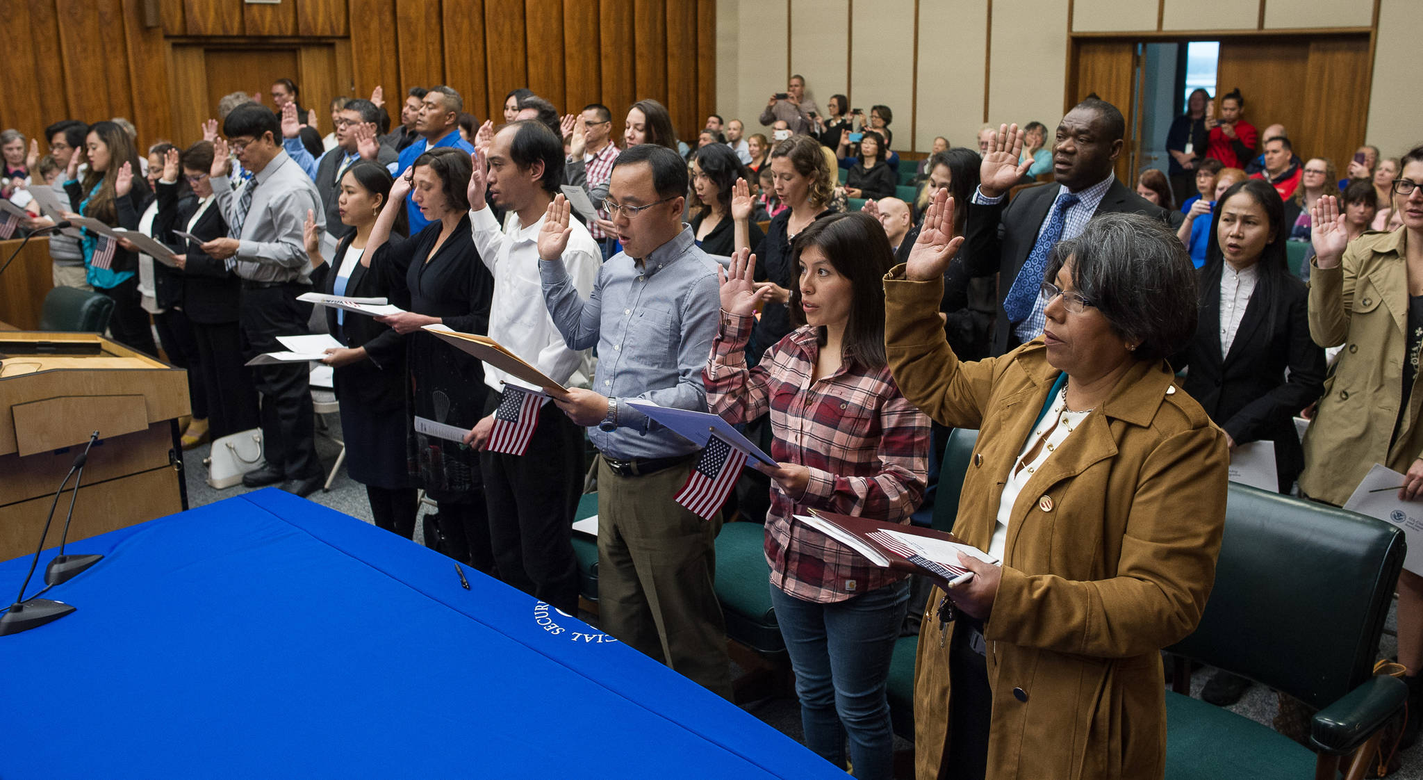 Over 30 people from around the world participate in a Naturalization Ceremony overseen by Magistrate Judge Scott Oravec of Fairbanks at the Robert Boochever Federal Courthouse in Juneau on Friday, Aug. 25, 2017. (Michael Penn | Juneau Empire)