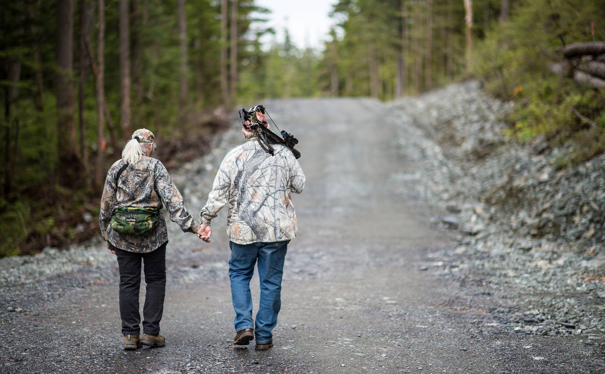 A couple walks along the West Douglas Pioneer Road on Monday, Aug. 28, 2017. The city has asked for permission to extend the road to Middle Creek. The road is now open to non-motorized traffic. (Michael Penn | Juneau Empire)