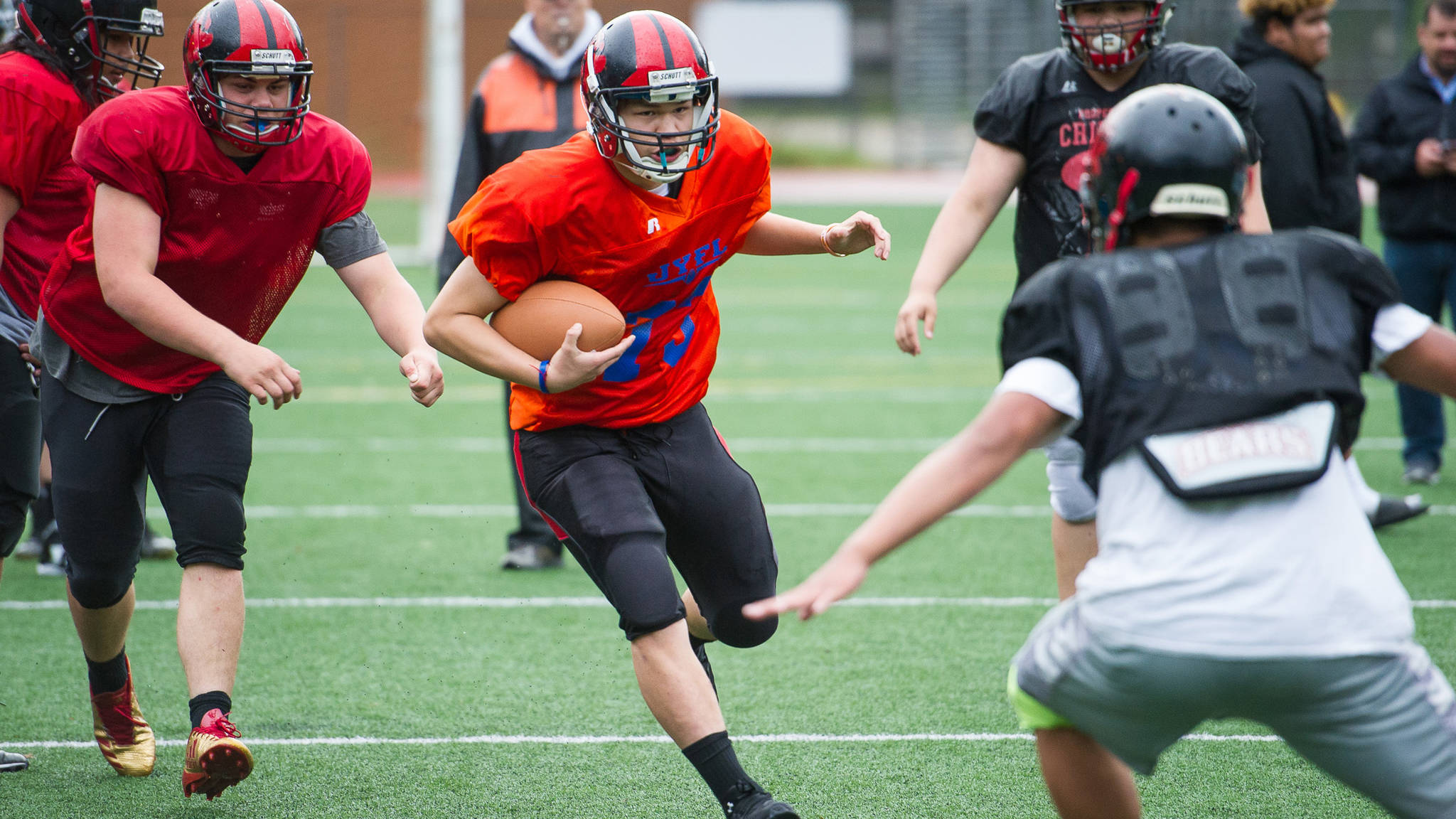 New starting quarterback Max Wheat runs the ball during Juneau-Douglas High School varsity football practice at Adair-Kennedy Memorial Park on Wednesday, Aug. 30, 2017.