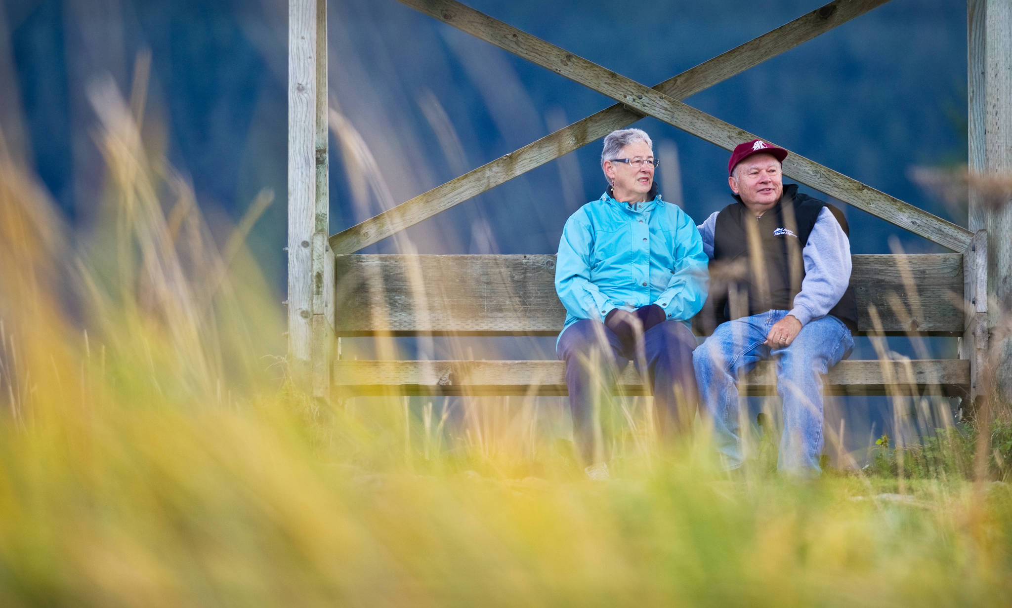 In this file photo from September 2013, Sherry and John Taber enjoy a view of the Mendenhall Wetlands State Game Refuge from a bench along the Airport Dike Trail. (Michael Penn | Juneau Empire File)