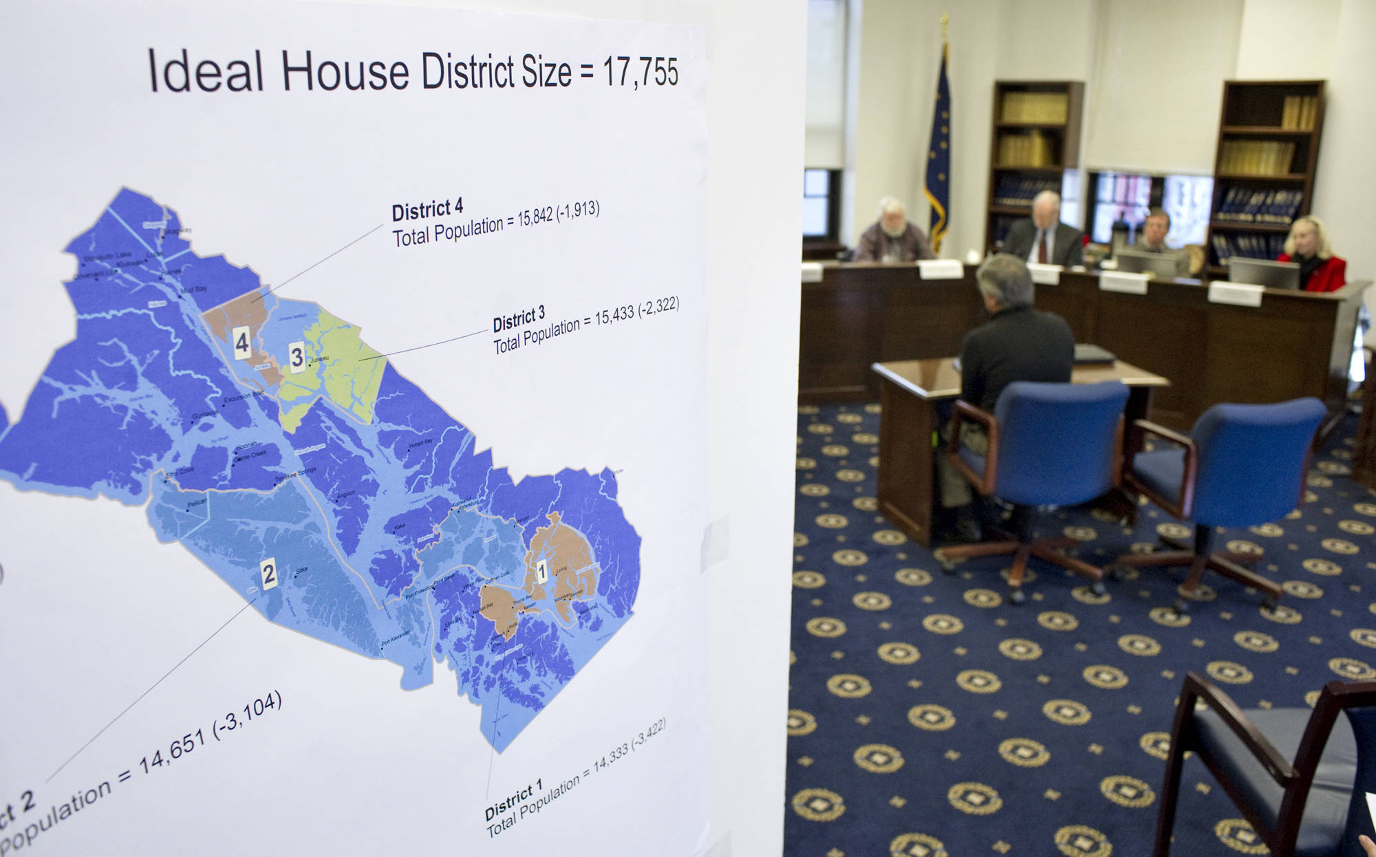 In this March 2011 photo, a House district map shows district population numbers as the Alaska Redistricting Board hears testimony at the Capitol. (Michael Penn | Juneau Empire File)