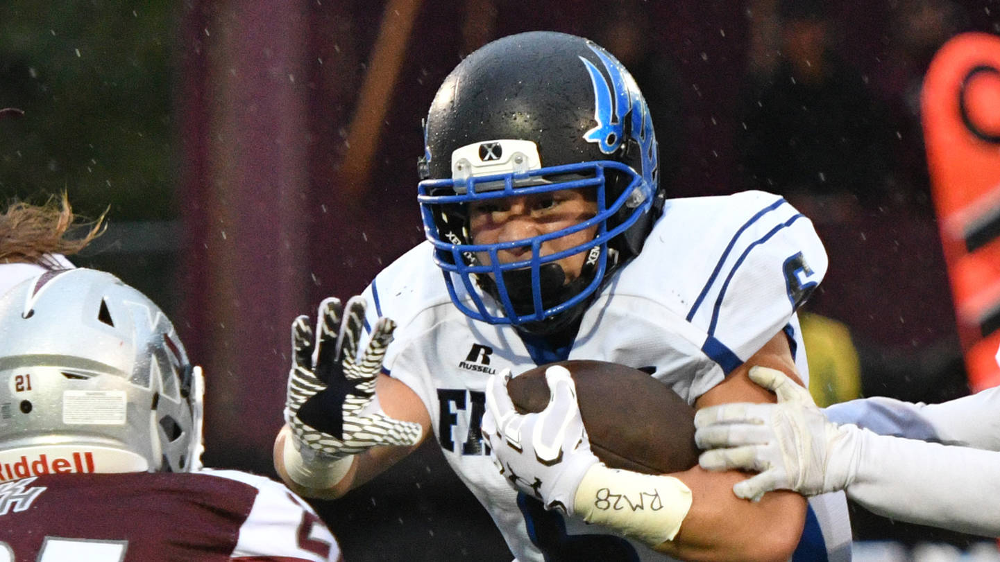 Thunder Mountain senior running back Roy Tupou dashes through defenders Friday, Sept. 8, 2017, during the Falcons&rsquo; 42-9 win against Ketchikan High School at Esther Shea Field. Tupou scored a 51-yard touchdown in the game. (Taylor Balkom | Ketchikan Daily News)