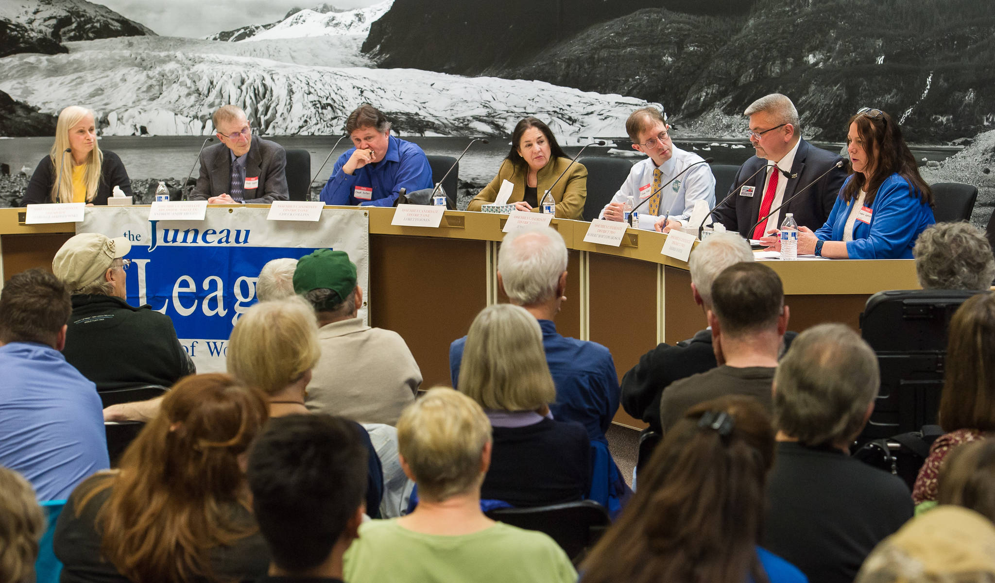 Assembly candidates Maria Gladziszewski, left, Andrew Hughes, Chuck Collins, Loretto Jones, Jesse Kiehl, Robert Edwardson, and Debbie White participate in the Juneau League of Women Voters forum in the Assembly chambers on Thursday, Sept. 14, 2017. (Michael Penn | Juneau Empire)