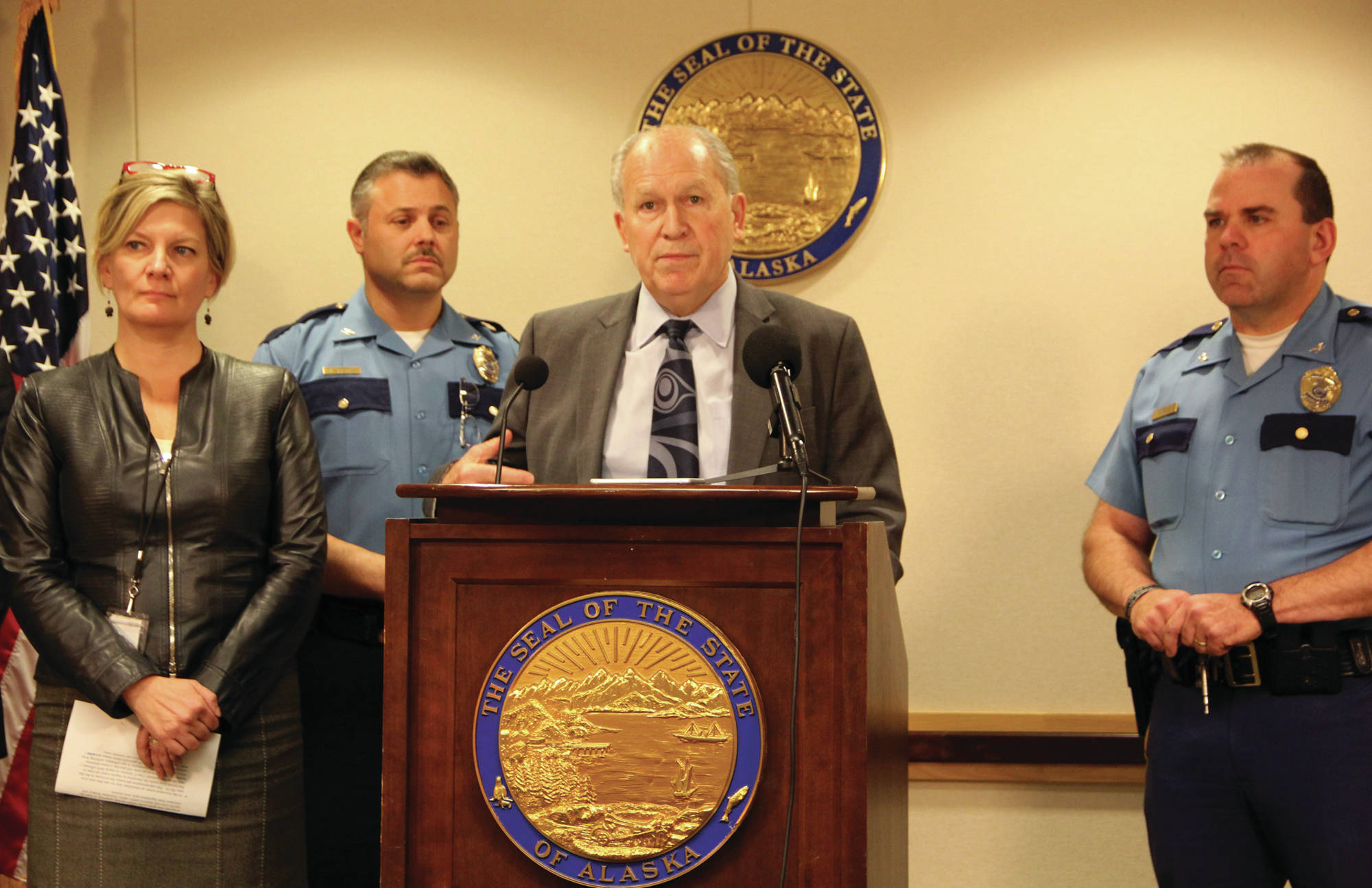 Gov. Bill Walker speaks to reporters during a Friday press conference in Anchorage. At left are Attorney General Jahna Lindemuth and Col. Hans Brinke, director of the Alaska State Troopers. To the right is Col. Steve Hall, director of Wildlife Troopers. (Alaska Journal of Commerce Photo)