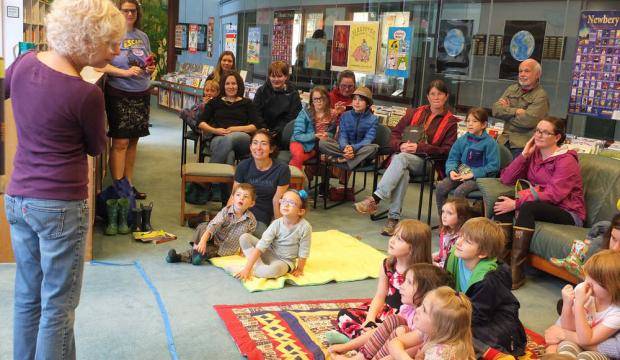 In this June 2015 photo, Kate DiCamillo, whose books have been New York Times bestsellers and won two Newbery Medals, reads during storytime at the Downtown Public Library. (Juneau Empire File)