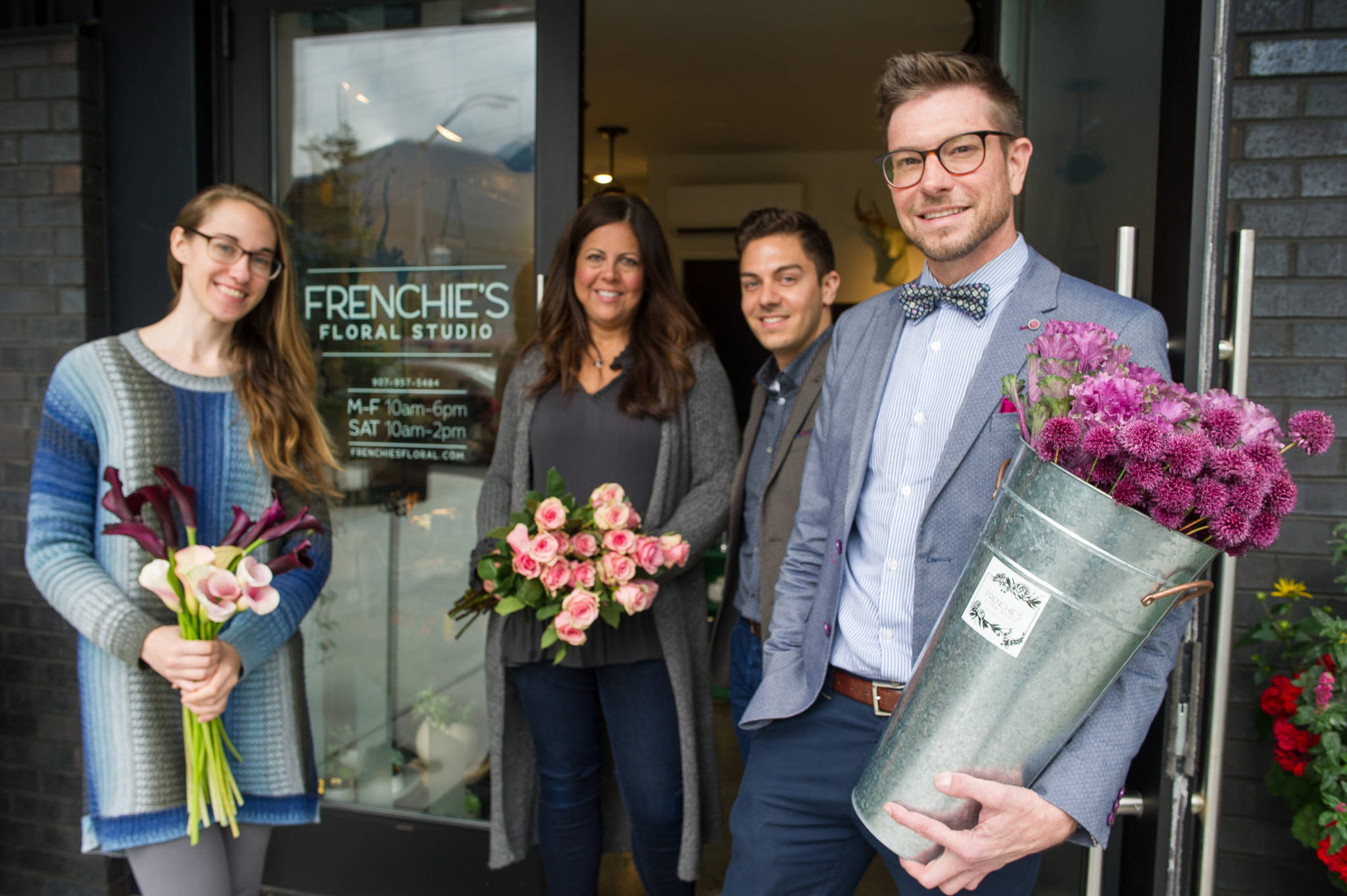 Owners Jeremy Bauer, right, and Jason Clifton pose with employees Erika Fagerstrom and Sara Tiberio, left, in front of their newest business, Frenchie’s Floral Studio, located at the corner of Glacier Avenue and 12th Street on Tuesday, Sept. 12, 2017. (Michael Penn | Juneau Empire)