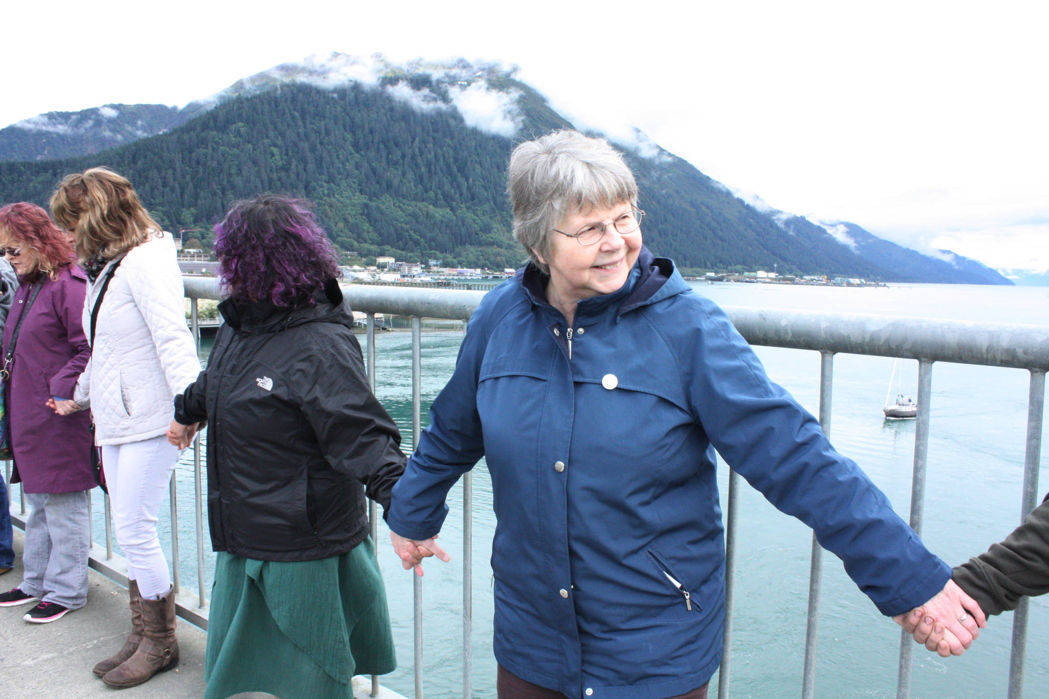 Sister Dee Sizler takes part reciting the Serenity Prayer on Sept. 18 at the Hands Across the Bridge event. (Erin Laughlin | For the Juneau Empire)