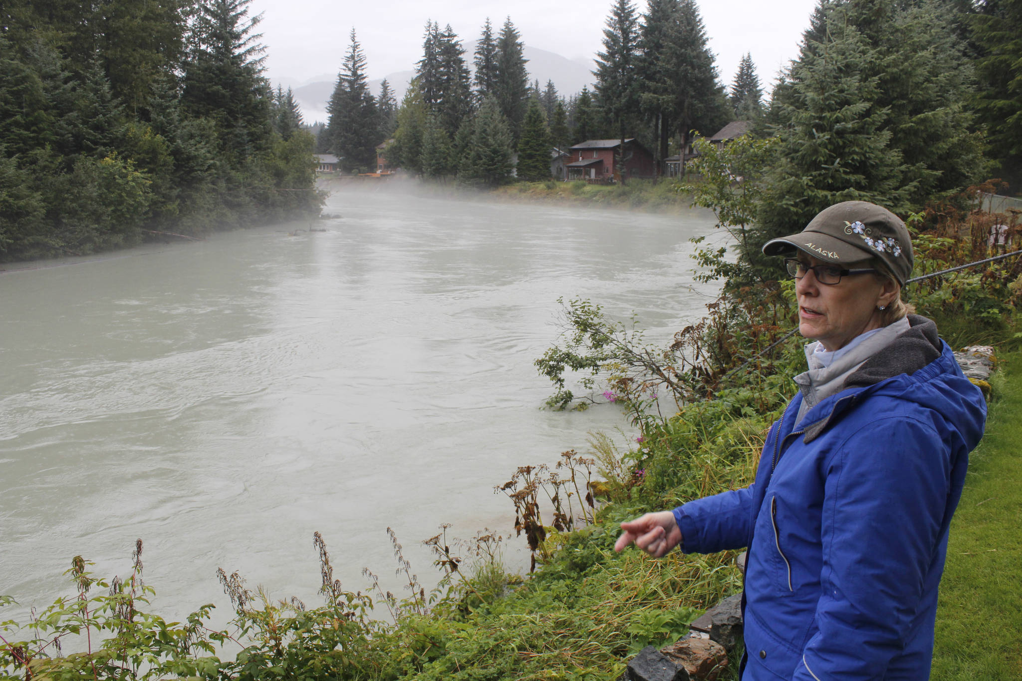 Meander Way resident Joyce Goehring overlooks the Mendenhall River from her backyard. Goehring feels that the current proposal from the Natural Resources Conservation Service to slow the erosion is too aggressive and invasive for homes that aren’t experiencing major erosion. (Alex McCarthy | Juneau Empire)