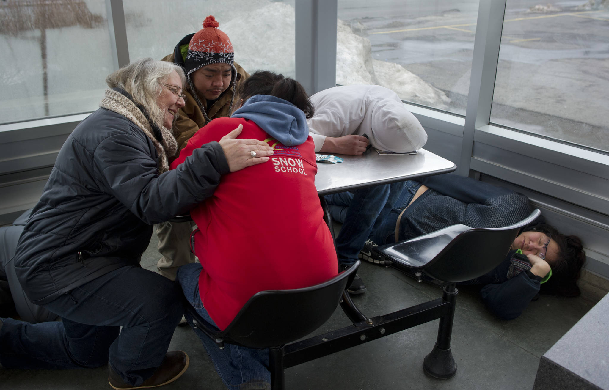 In this March 25 photo, Cindy Dau, left, checks on homeless people sleeping in the downtown Transit Center. (Michael Penn | Juneau Empire File)