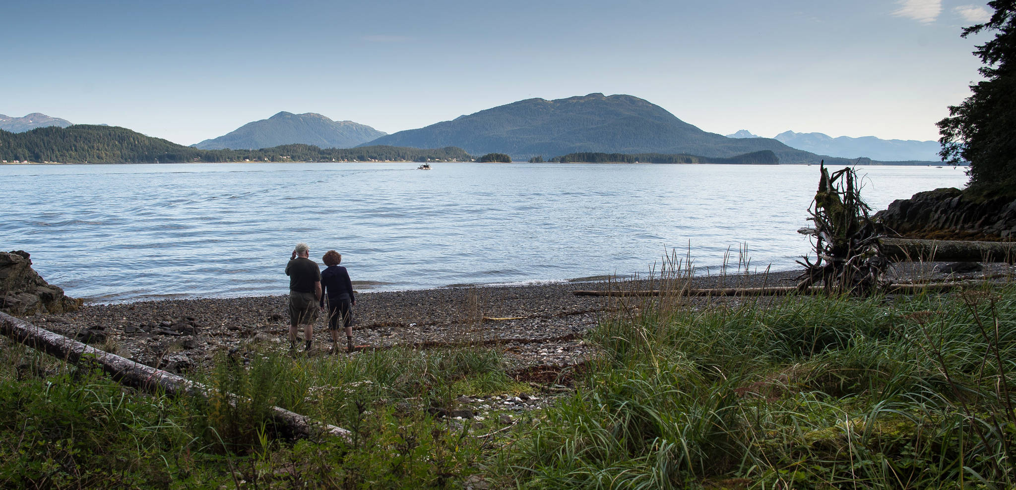 Natalee Rothaus and Mike Stanley take in the view of Auke Bay during a hike on the Indian Point Trail on Tuesday, Sept. 5, 2017. (Michael Penn | Juneau Empire)