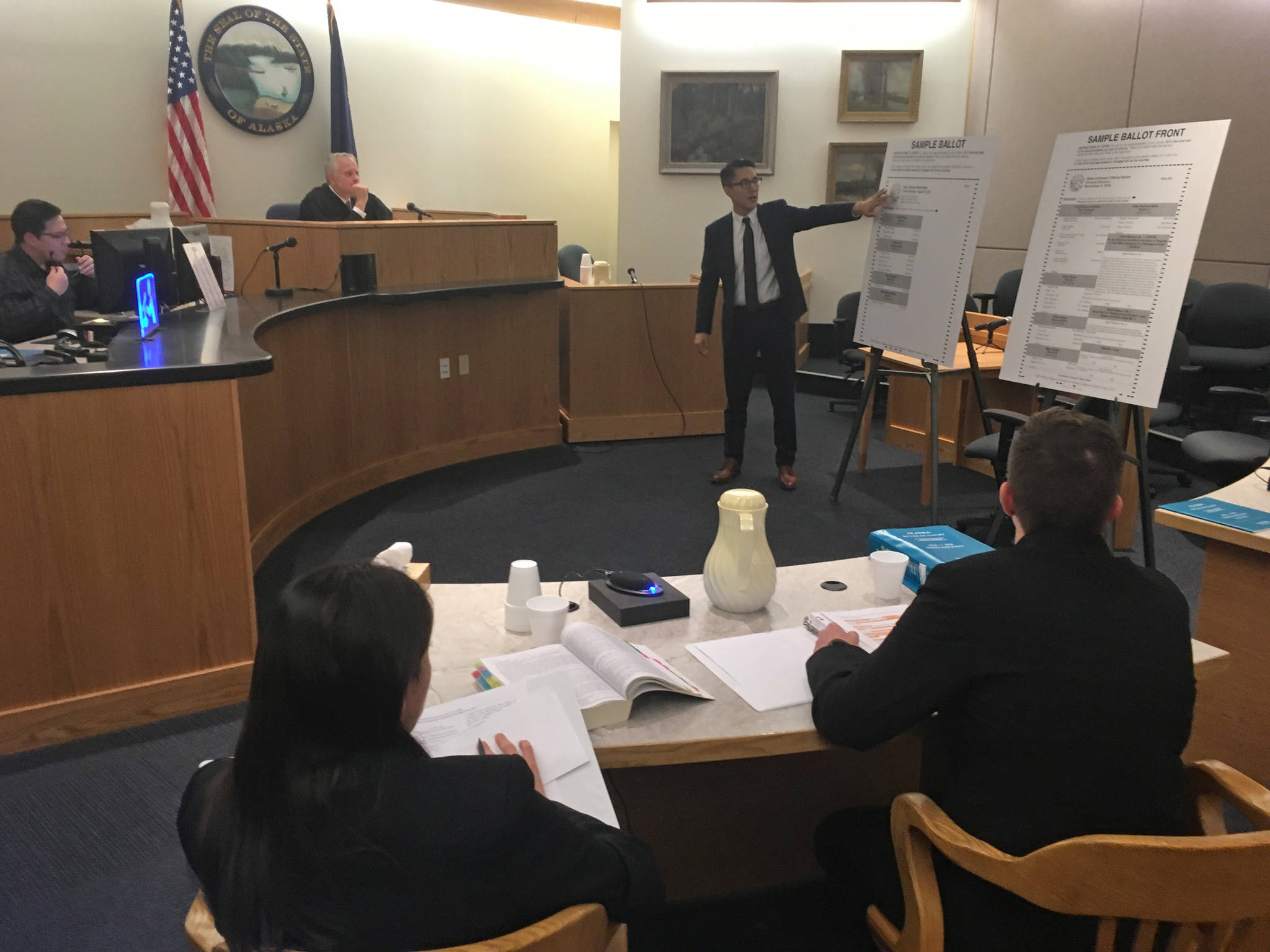 State attorneys Elizabeth Bakalar, foreground left, and Margaret Paton-Walsh, foreground right, listen to arguments made by attorney Jon Choate on Thursday, Sept. 21, 2017 in Alaska Superior Court in Juneau. At background left is Judge Philip Pallenberg, who is expected to decide the Alaska Democratic Party’s lawsuit against the state next week. (James Brooks | Juneau Empire)