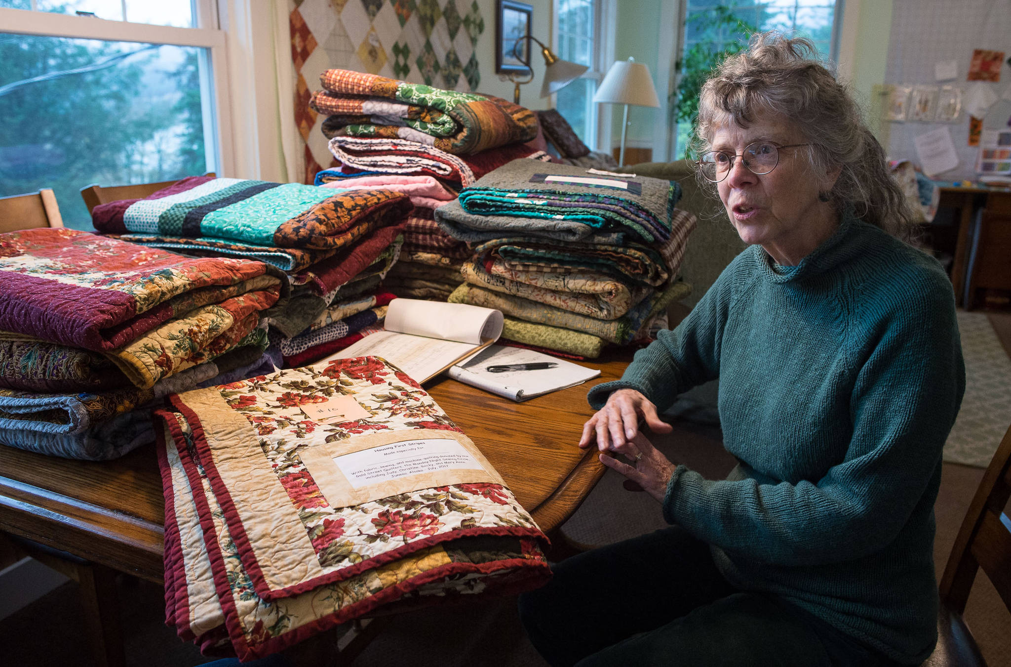 Odette Edgar talks about the handmade quilts she helped make and organize for the Housing First residents at her house on Tuesday, Sept. 26, 2017. (Michael Penn | Juneau Empire)